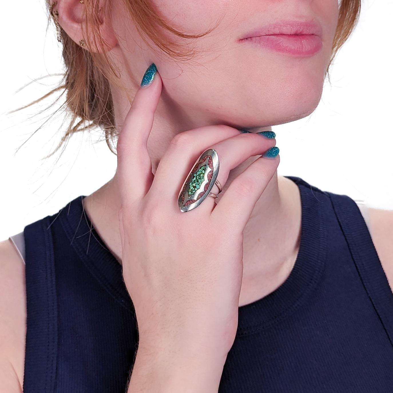 A fine vintage Southwestern ring.

In silver and inlaid with chip turquoise and spiny oyster.

With a navette-shaped head and a double band ring.

Simply a fine Southwestern ring!

Date:
20th Century

Overall Condition:
It is in overall good,