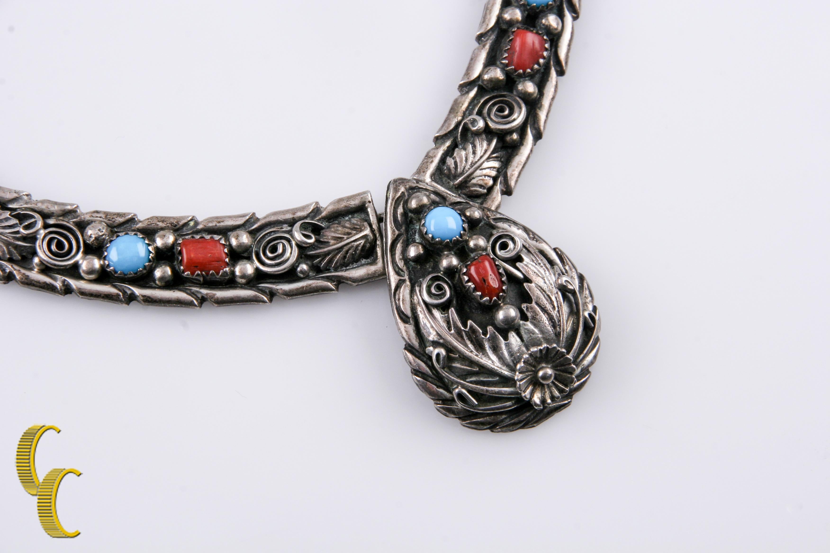 Vintage sterling silver necklace.
5 turquoise and 5 coral stones.
Beautiful floral and feather design on 4 panels and pendant.
Signed 