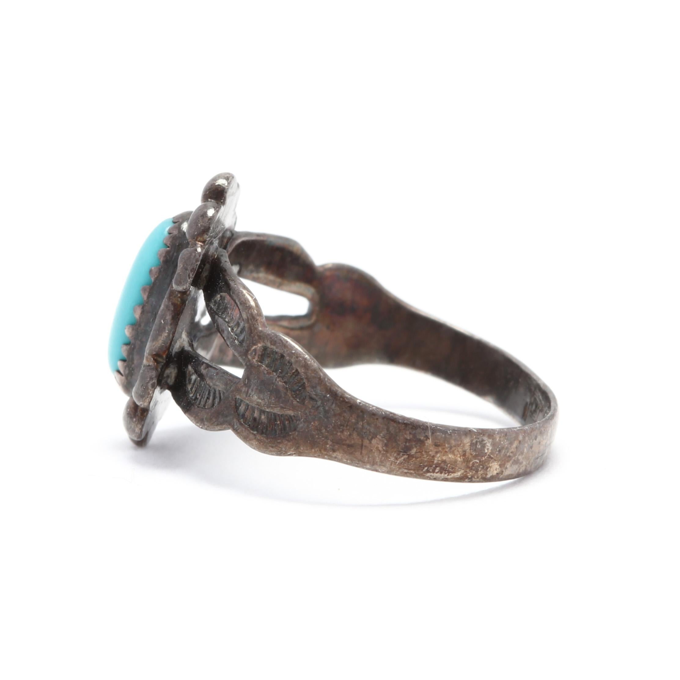 A southwestern sterling silver and turquoise ring. This ring features an oblong, oval turquoise stone surrounded by scroll and bead motifs and with a split shank.

Stone:
- turquoise
- oval cabochon, 1 stone
- 7 x 3.5 mm

Ring Size 3.5

1.51