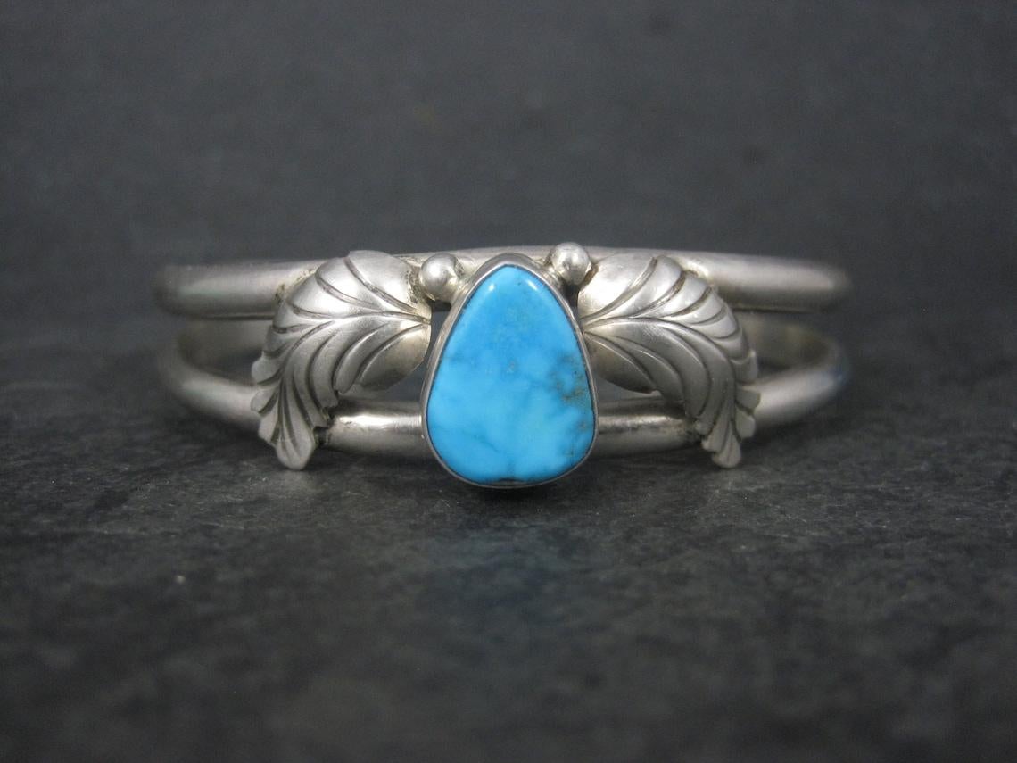 This gorgeous vintage cuff bracelet is sterling silver with a natural 10x13mm turquoise stone.

The face of this cuff bracelet measures 5/8 of an inch wide.
It has an inner circumference of 6 1/4 inches including the 1 inch gap.
Weight: 24.6