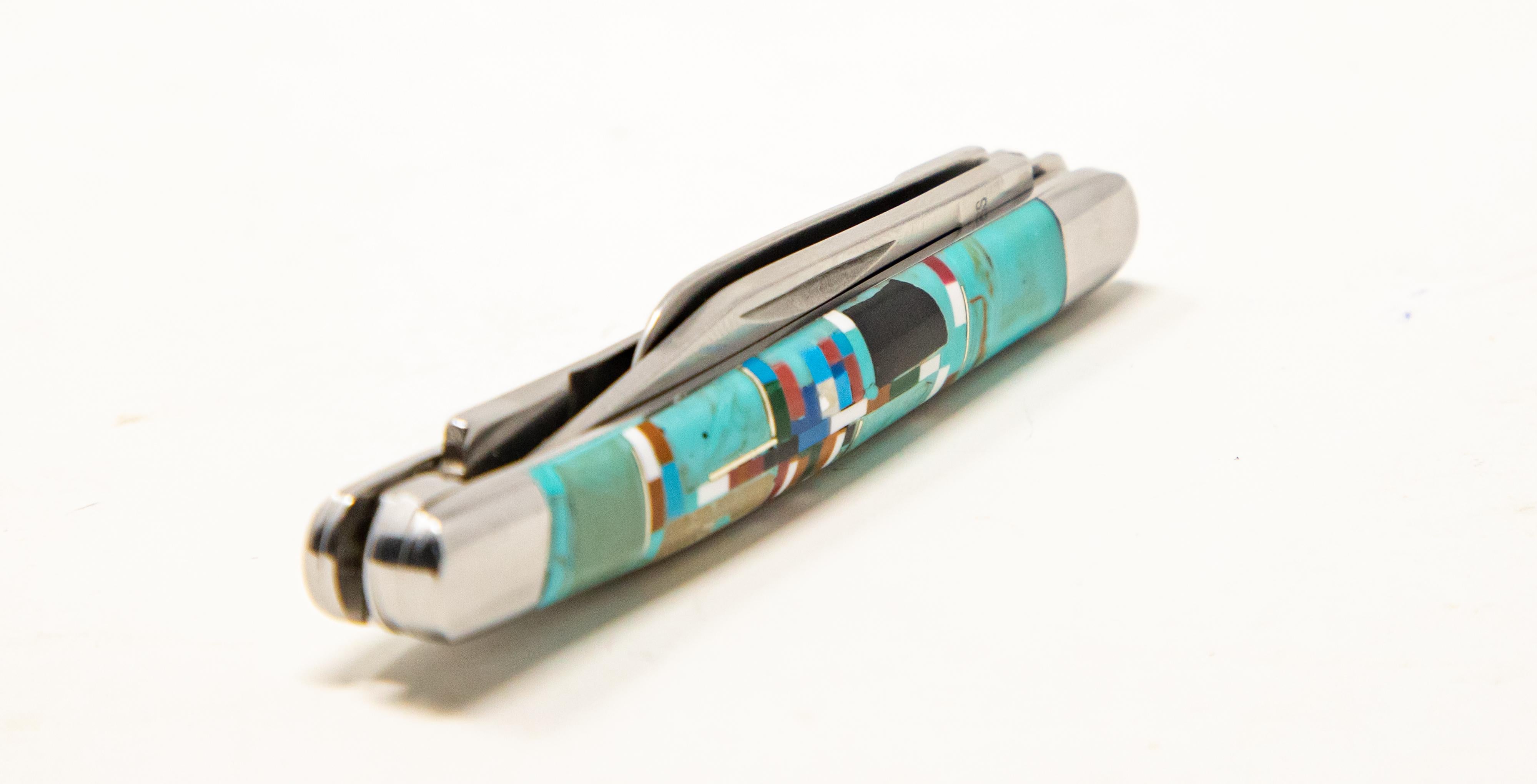 Offering this interesting pocket knife with stonework and inlay in many colors. The main color is turquoise and has reds, blues, and whites. Three stainless blades that fold out in different sizes.