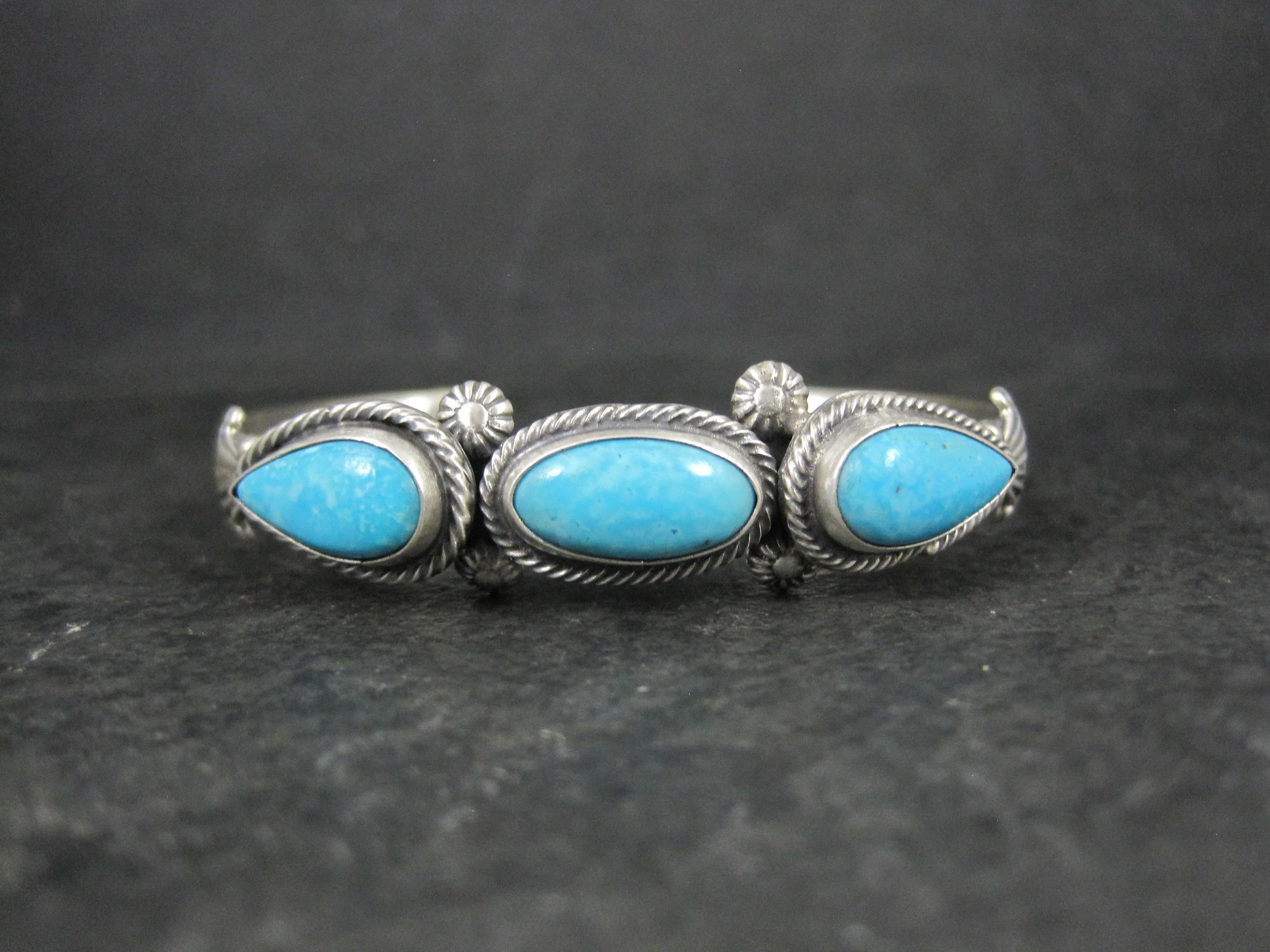 This beautiful cuff bracelet is sterling silver with 3 genuine turquoise gemstones.

The face of this cuff bracelet measures 1/2 of an inch wide.
It has an inner circumference of 6 inches including the 1 inch gap.
Weight: 20.7 grams

Made by Navajo