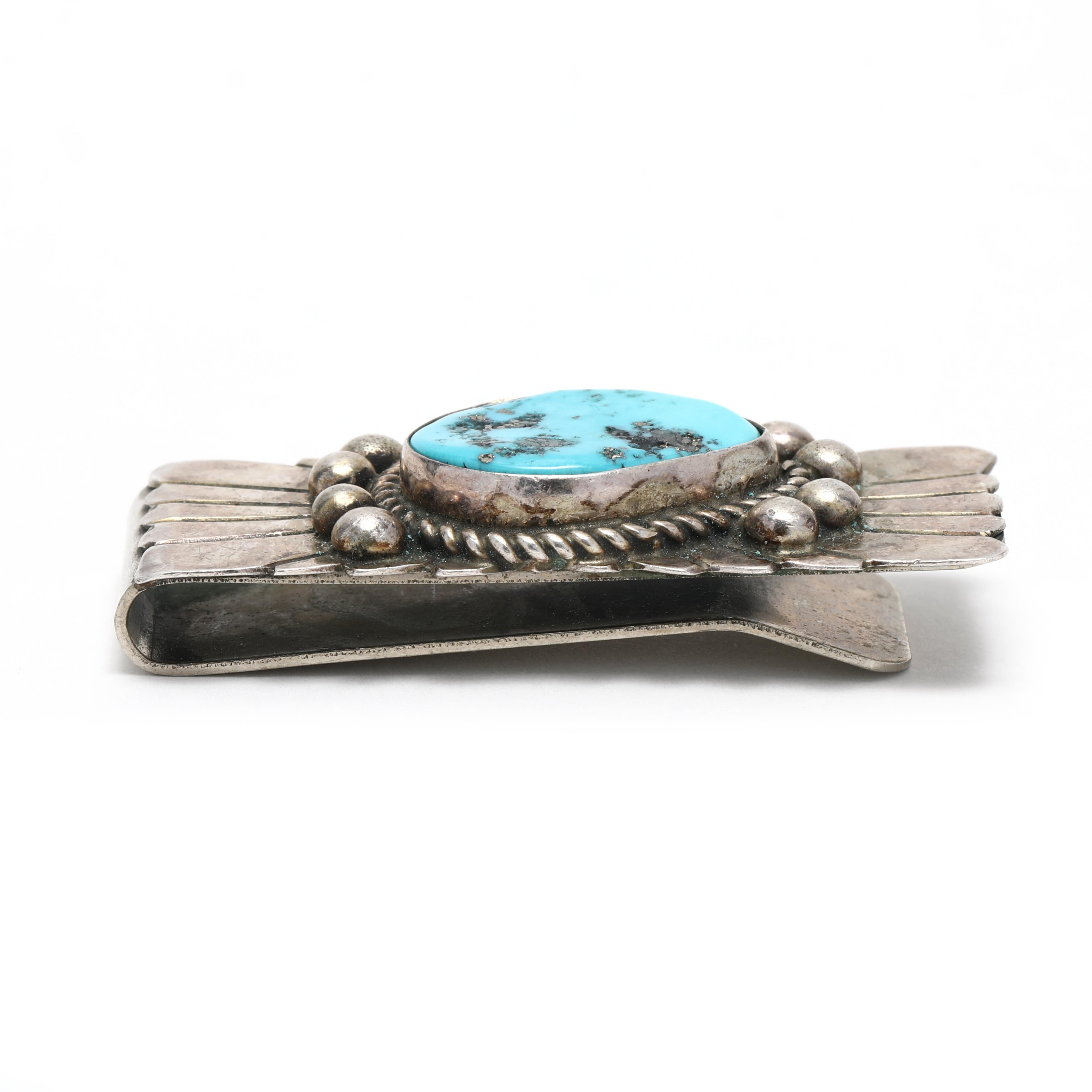 This stunning Southwestern-style money clip is the perfect way to keep your money secure in style! Handcrafted from sterling silver, this stunning vintage money clip features a beautiful turquoise stone in the center. The length of this money clip