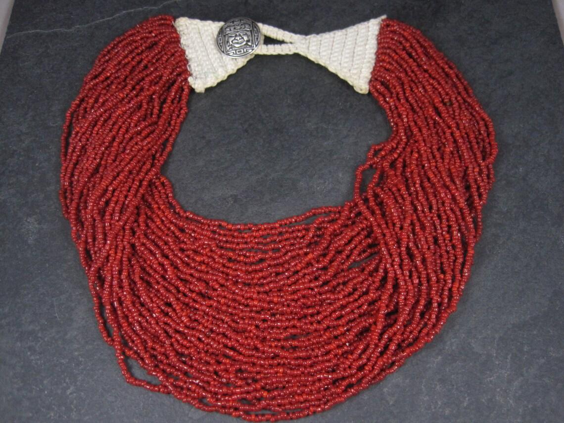 This gorgeous Southwestern necklace features 40 strands.
The macrame top clasps with a sterling silver Pre Columbian style button.

Measurements: 20.5 wearable inches

Weight: 159.3 grams

Condition: Excellent
