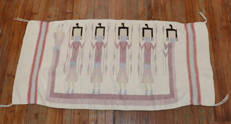 Vintage Navajo rug pictorial weaving with five Yei (Yeibichai) figures holding feathers. Woven of native hand-spun wool in natural fleece yarns in gray, ivory/white brown, and lavender
This textile is well suited for use on the floor as a rug or as