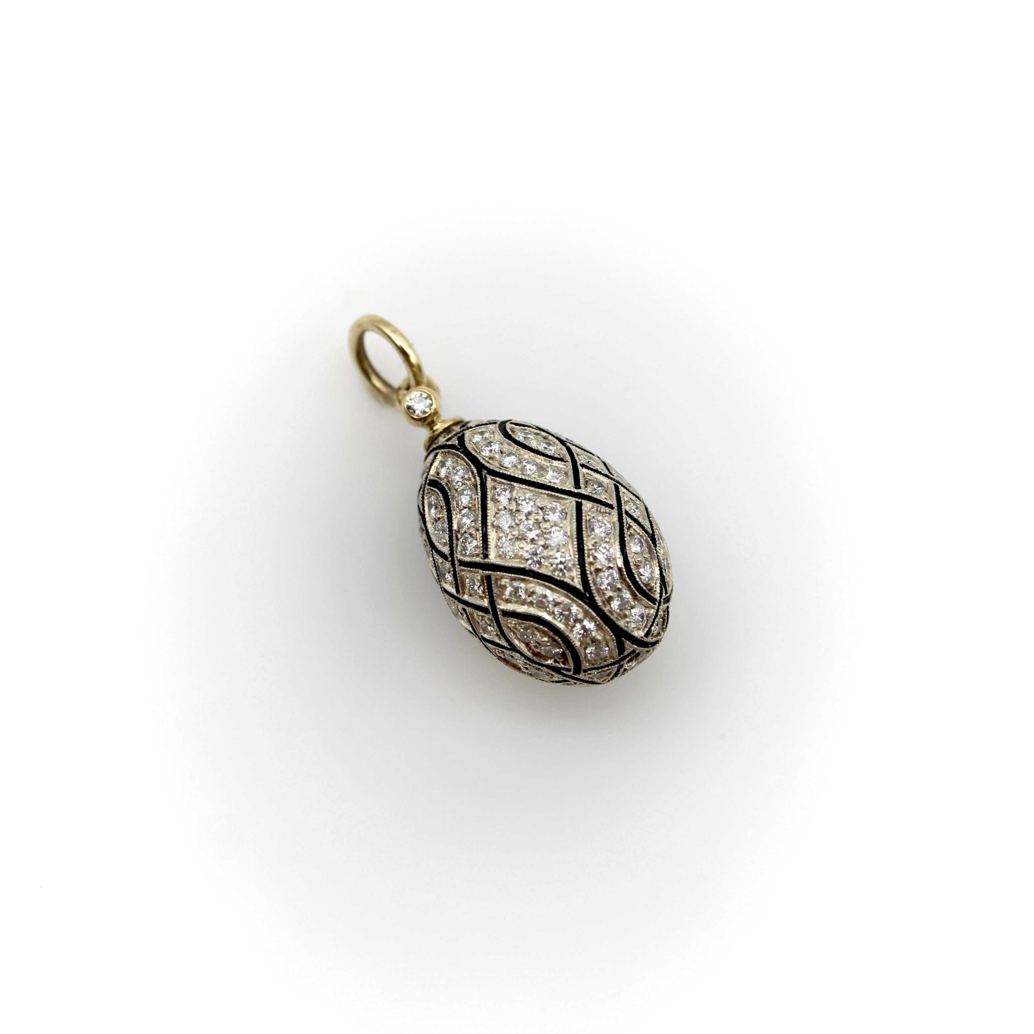 An opulent 18k gold and silver egg pendant, with a look and feel inspired by Karl Fabergé and the jewelers of Pre-Revolutionary Russia. The pendant contains 133 small diamonds covering the surface of the silver, in a pattern delineated by