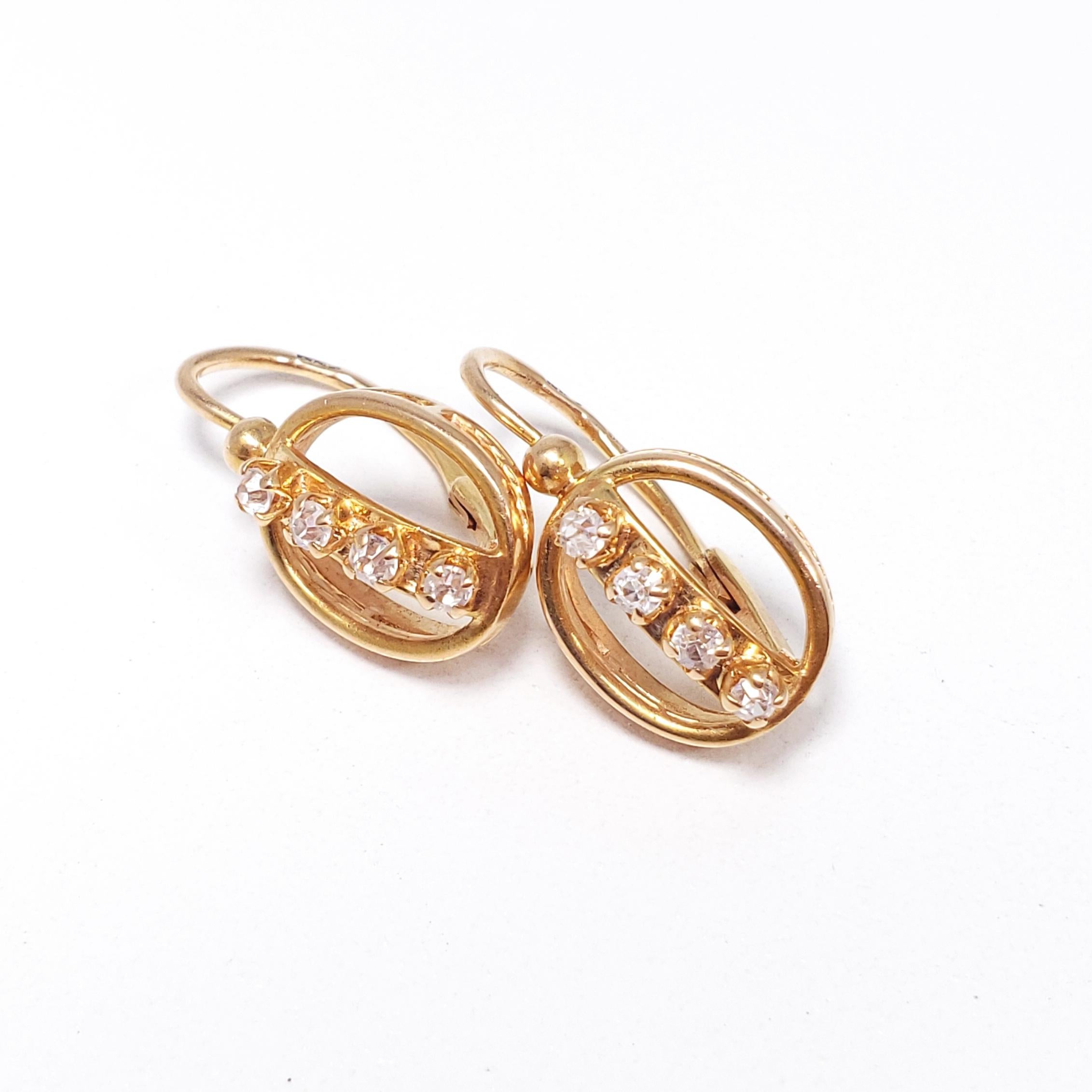 A pair of 583 gold earrings, each accented with 4 prong set Fianit stones. The Soviet's breakthrough technique of producing Fianit in 1973 later became popularized throughout the world - today,  the gem is most popularly known as cubic