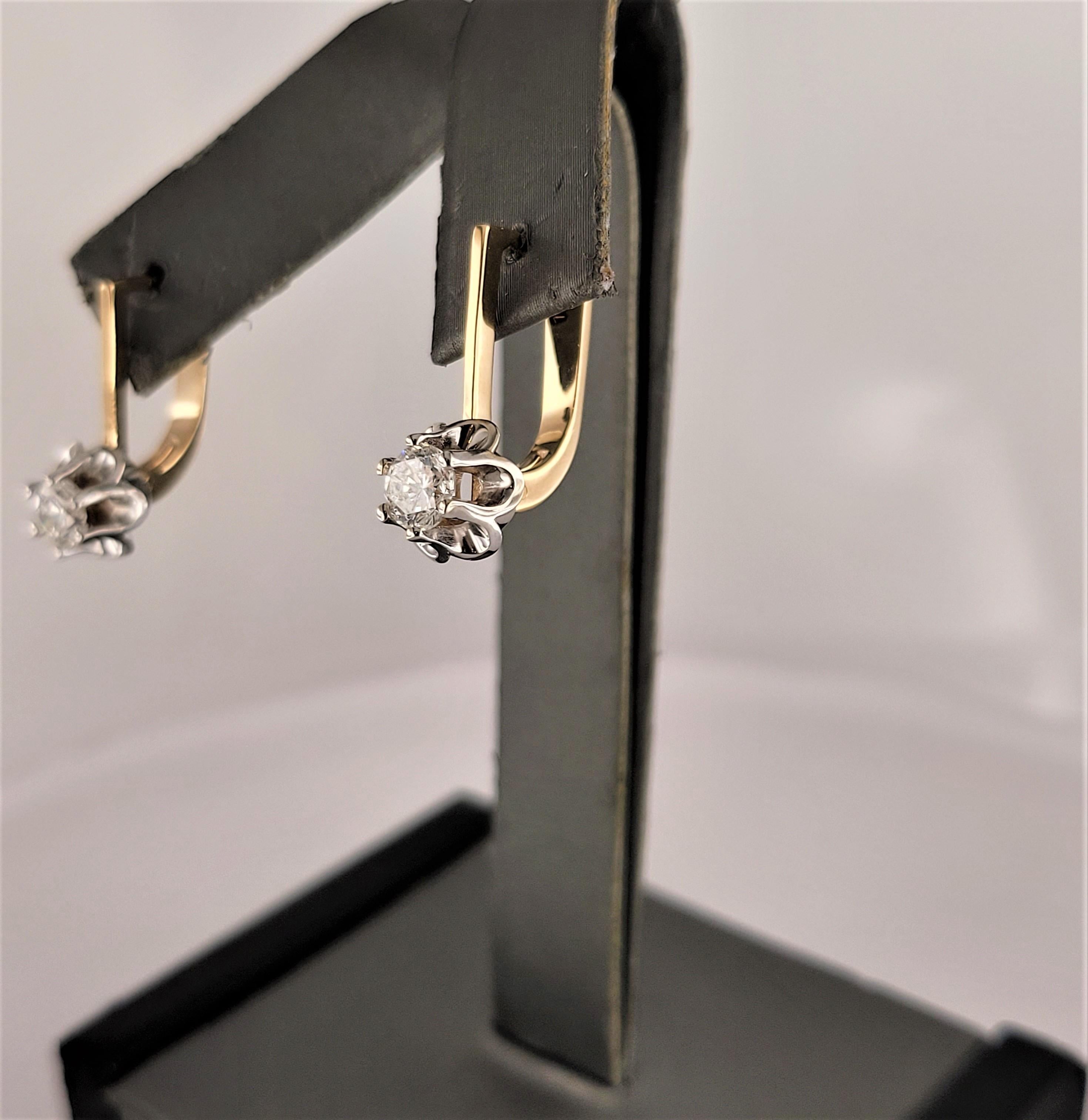 These soviet Russian earrings, crafted in 14K yellow & white gold, embody the timeless elegance and craftsmanship of the era. Their classic design offers a touch of history and sophistication, making them a unique addition to any jewelry