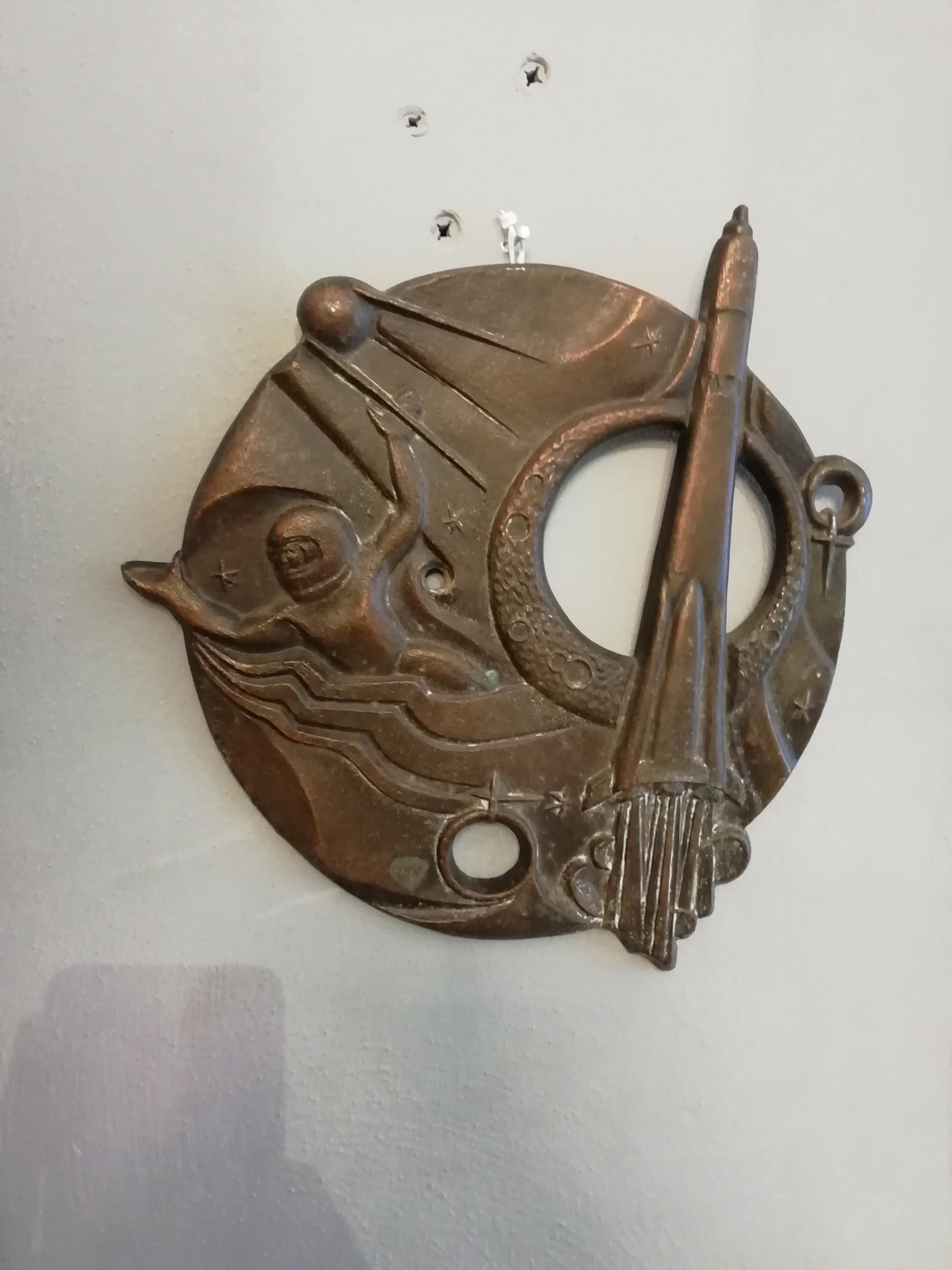 Interesting 1960s soviet bronze wall decoration depicting the Soyuz rocket, a sputnik satellite and a cosmonaut. The openwork round design shows marks on the back.
