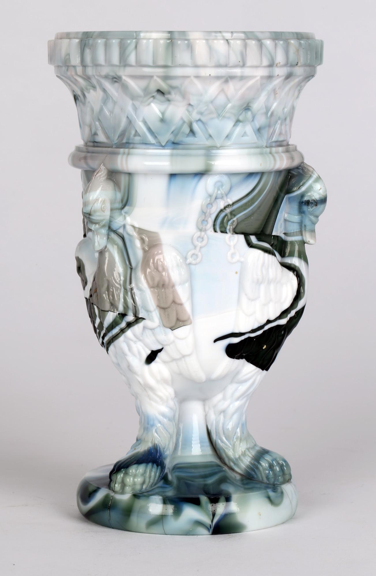 A superb quality Sowerby turquoise green, blue and white marbled slag glass vase molded with three chained swans with lion paws dating from around 1880. The vase is crisply molded with excellent detail in muted and bold colors. Often referred to as