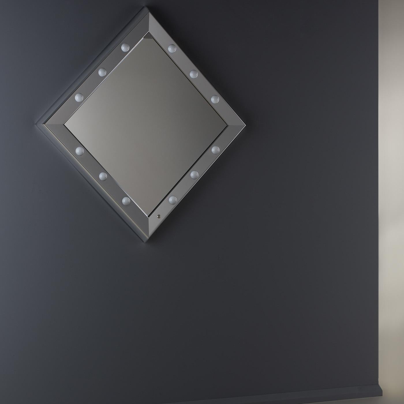 The high-tech features and classic shape of this stunning lighted mirror from the SP line will add brilliance and style to any interior.  The opal lenses diffusing the six I-light light enrich with reflections the polished geometric surfaces of the