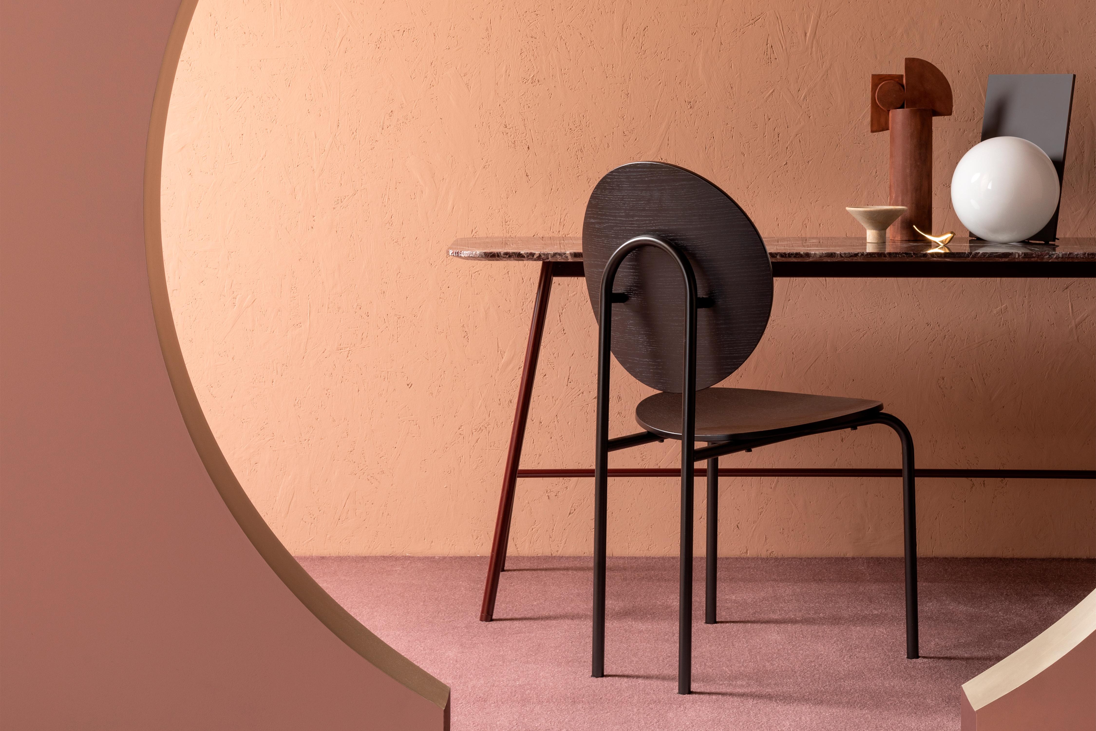 Building on the success of the Michelle mirror series, Tim Rundle has developed the visual language of the arc to create seating that is an exercise in architectural geometry. On its own, a single Michelle chair makes a bold style statement, the
