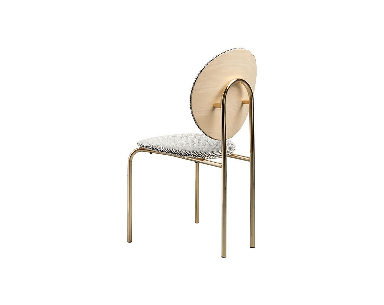 The Michelle chair makes a bold style statement with a disc shaped back mounted upon an arch shaped tubular steel frame creating a unique sculptural form. With a subtle nod to the 1970s and 1980s the Michelle appears luxe in metallic gold paired