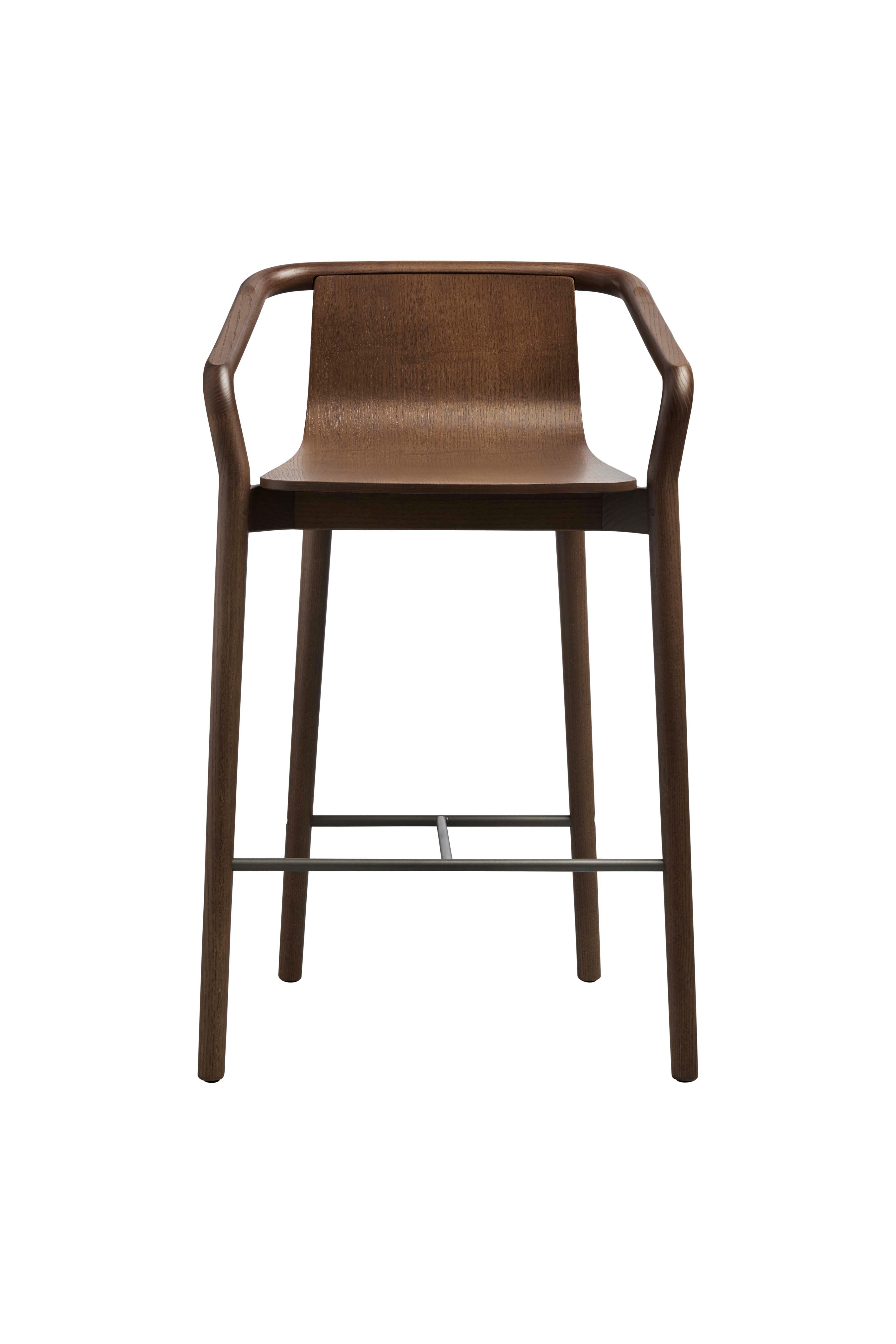 The Thomas barstool completes the Thomas Family and is derived from the same design elements that define the series. Featuring a formed plywood shell suspended in a solid ash frame with the distinctive carved armrest detail, the stool features a