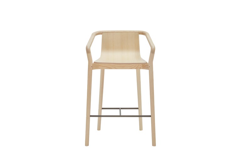 The Thomas mid-height barstool completes the Thomas Family and is derived from the same design elements that define the series.
Featuring a formed plywood shell suspended in a solid ash frame with the distinctive carved armrest detail, the footrest