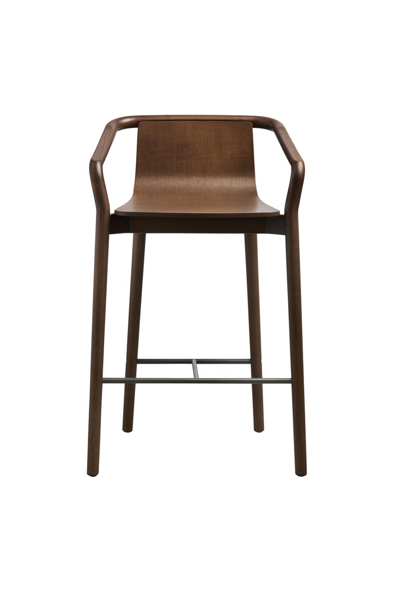 The Thomas mid-heaight barstool completes the Thomas Family and is derived from the same design elements that define the series.
Featuring a formed plywood shell suspended in a solid ash frame with the distinctive carved armrest detail, the