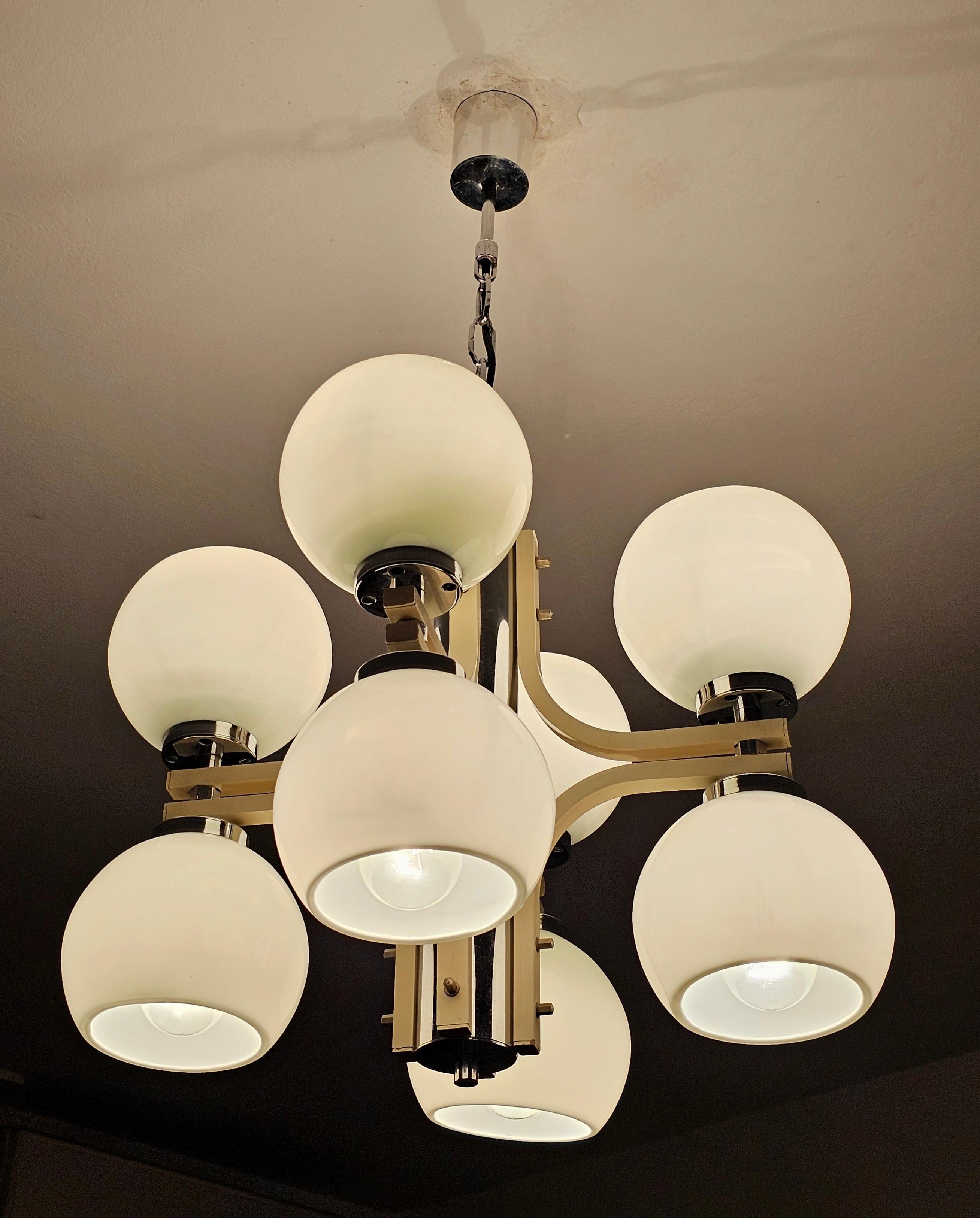 In this listing you will find a stunning Space Age 4-Arm Chandelier with 8 lights placed in white glass balls with open ends. Chandelier features silver and ivory metal fixture. Made in Yugoslavia in 1970s.

Very good vintage condition with small