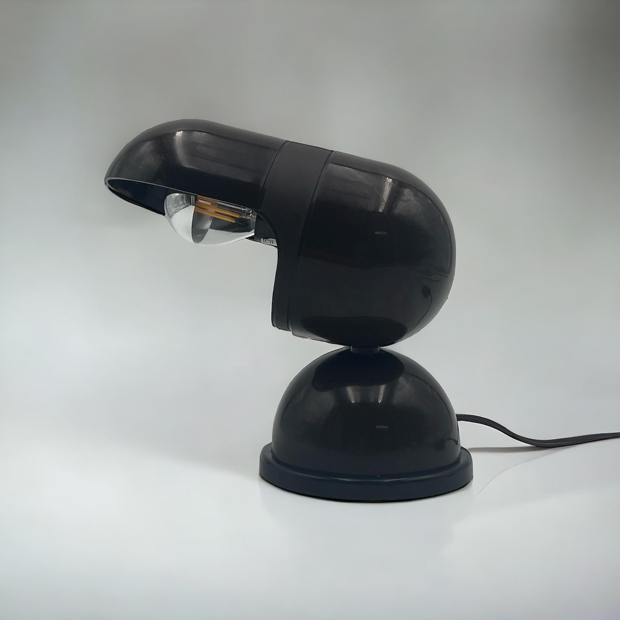 Explore the cosmos of vintage design with the 1970s UFO Lamp by Gamma Lux, a true emblem of space age ingenuity crafted in Italy. This unique lamp features a half-sphere base and a quirky lampshade with a pill-like shape, evoking a perfect blend of