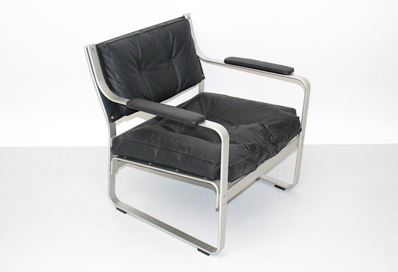 Space Age vintage lounge chair or club chair or side chair from aluminum and black faux leather by
Karl- Erik Ekselius for JOC Vetlanda Sweden.
Throughout its aluminum frame in silver tone the lounge chair spreads a lightweight appearance.
Very