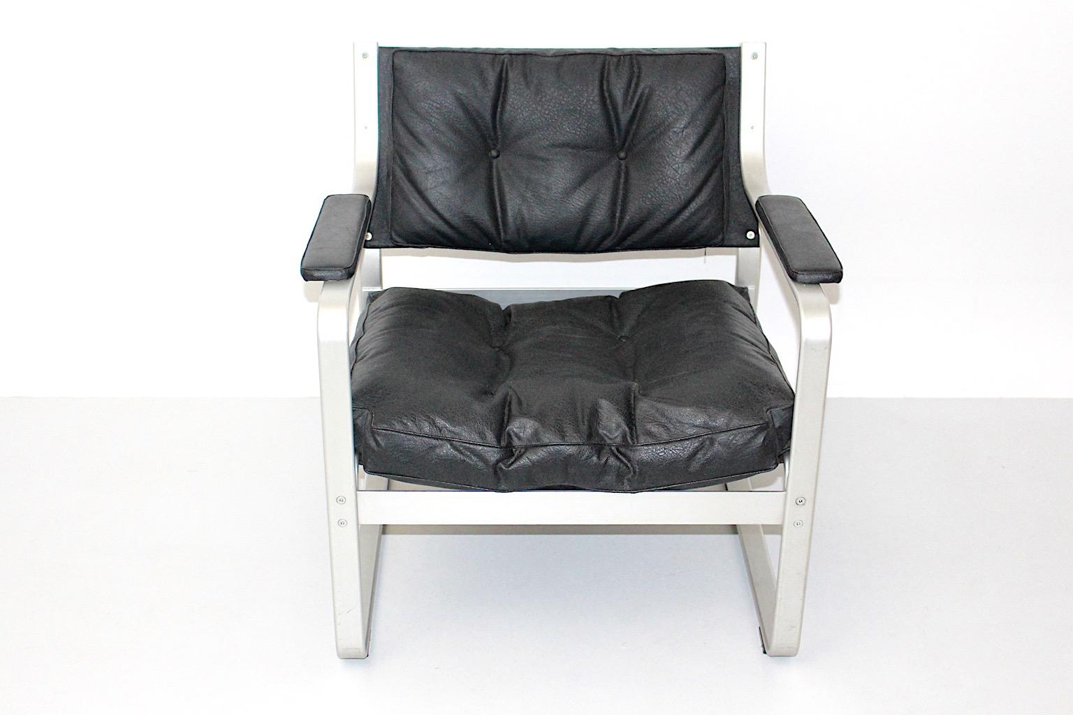 pair of vintage lounge chairs in aluminum and plastic