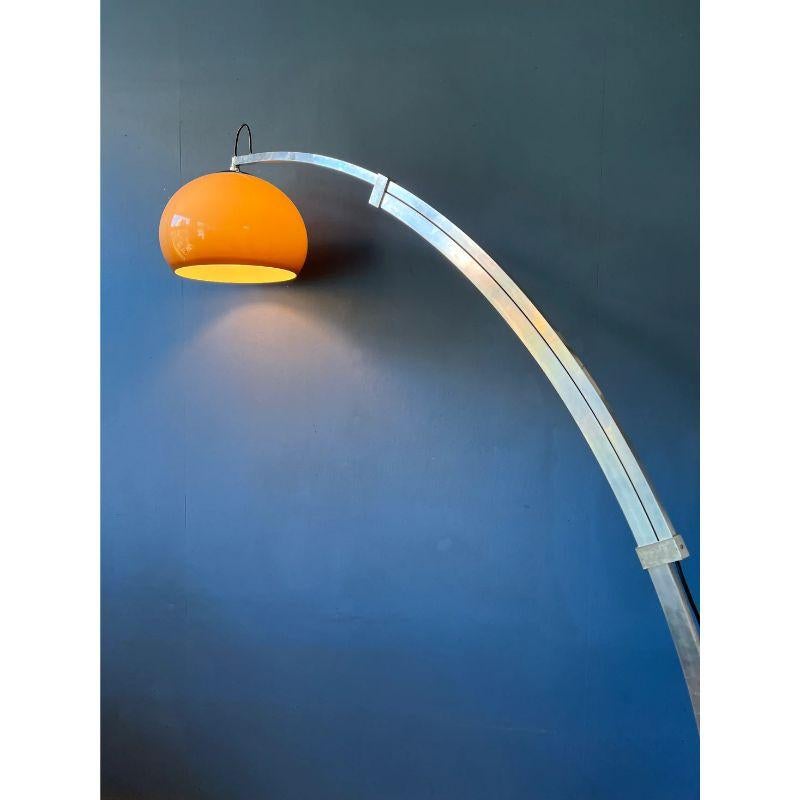 One of a kind arc floor lamp with extendable arm and mushroom shade. We are not sure about the brand, but it has the looks of Guzzini. The thick acrylic glass shade produces a warm glow. It has a large and very heavy limestone base. The