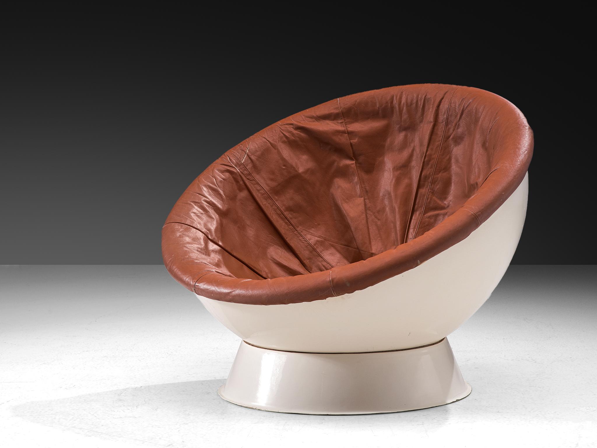 Lounge or ball chair, fiberglass, leather, Italy, 1960s

This pop-cultural lounge chair features a concave-shaped seat perched atop a conical base. The base securely supports a hemispherical ball, enabling the seat to rotate and allowing the user to