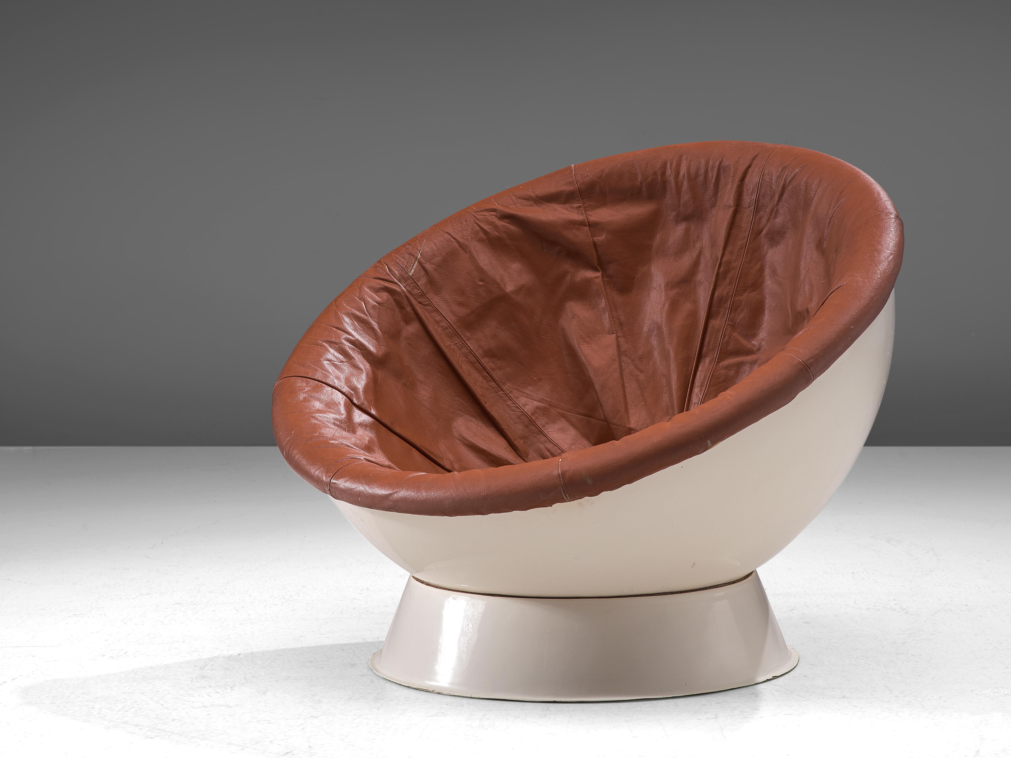 Lounge or ball chair, fiberglass, leather, Italy, 1960s

Pop-cultural lounge chair, consisting of a crescent seat. The conical shaped base holds the hemispherical ball in place which can be rotated, allowing the user to adjust the angle of the seat.