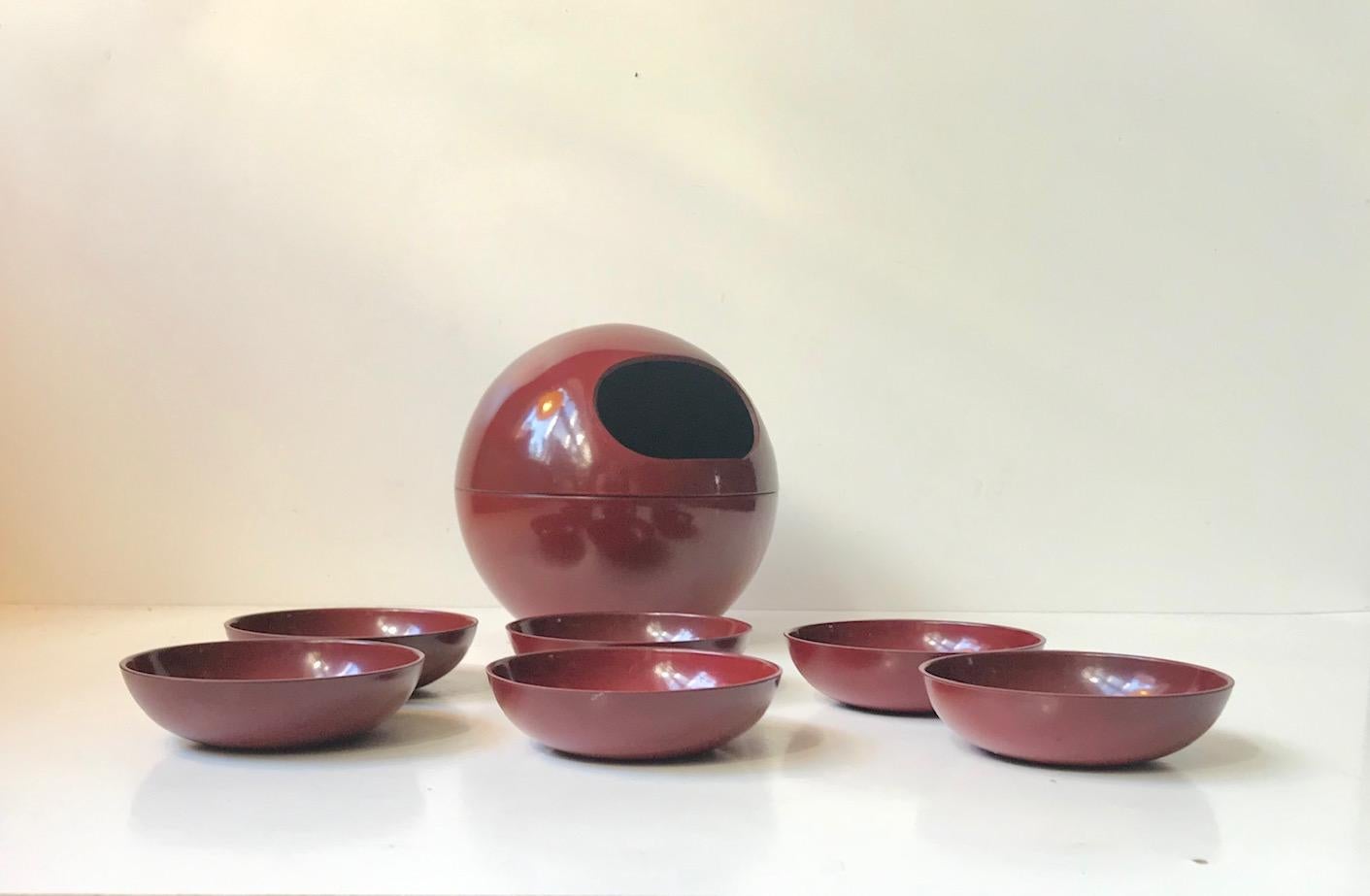 Barware, snack or peanut dispenser and 6 matching bowl. Spherical shape and composed of lacquered resin. Manufactured in Japan during the late 1960s or early 1970s. The 6 bowl is meant to be stored within the dispenser.