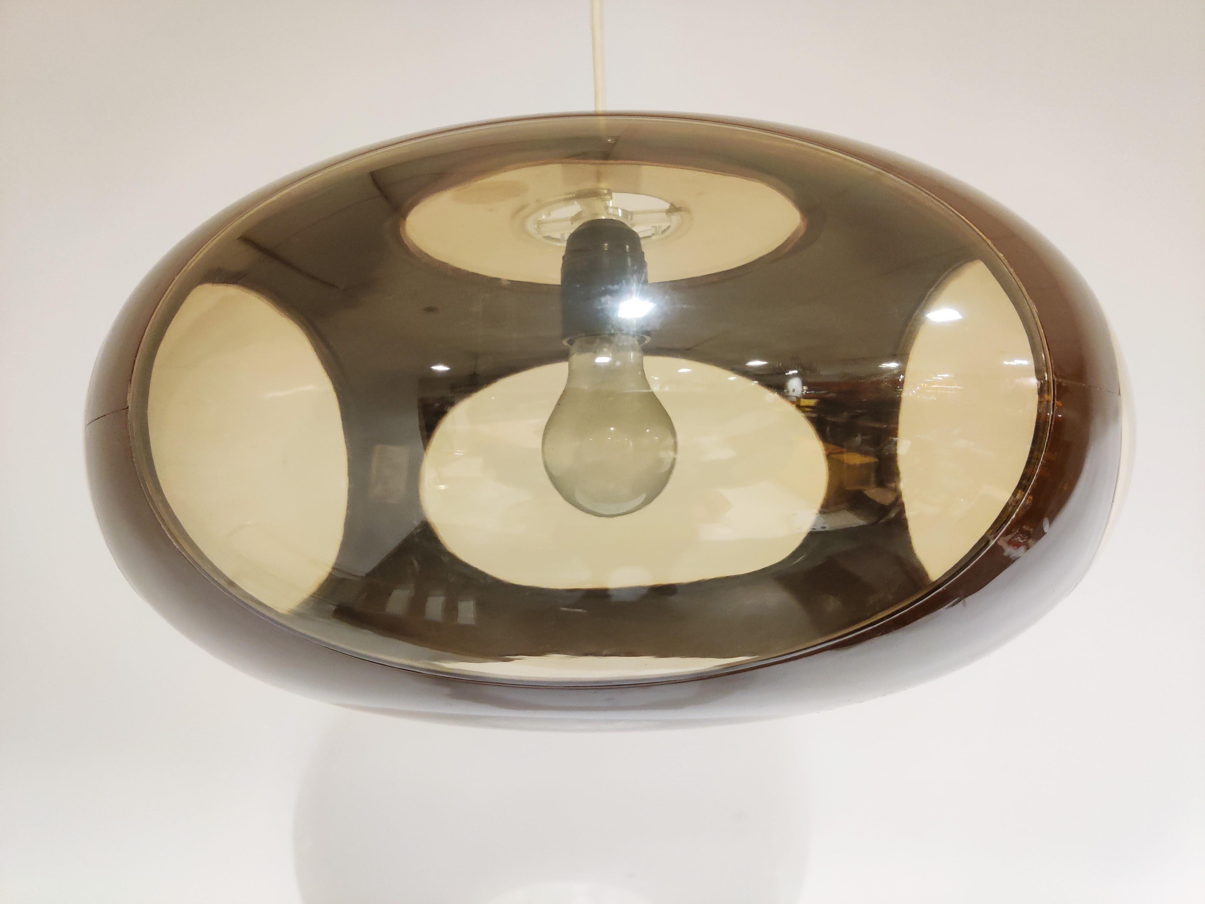 Midcentury Space Age 'bug eye' or UFO pendant light by Massive.

The lamp is mostly referred to as Luigi Colani design but is not correct. These where produced in Belgium by a lighting company called Massive.

Nevertheless it is a great original