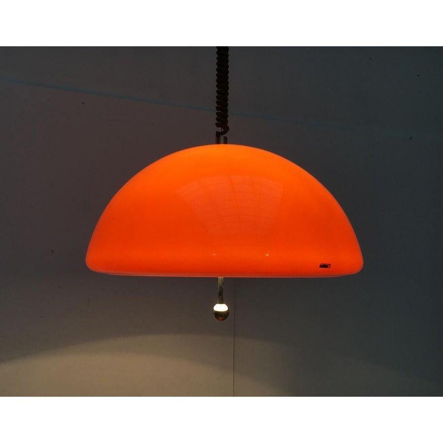 Rare train pendant lamp of Harvey Guzzini.

The large plastic screen is executed in orange. On the inside of the screen is white. Thus, the light completely functional casts white light down. Externally the screen staged as imposing luminous object