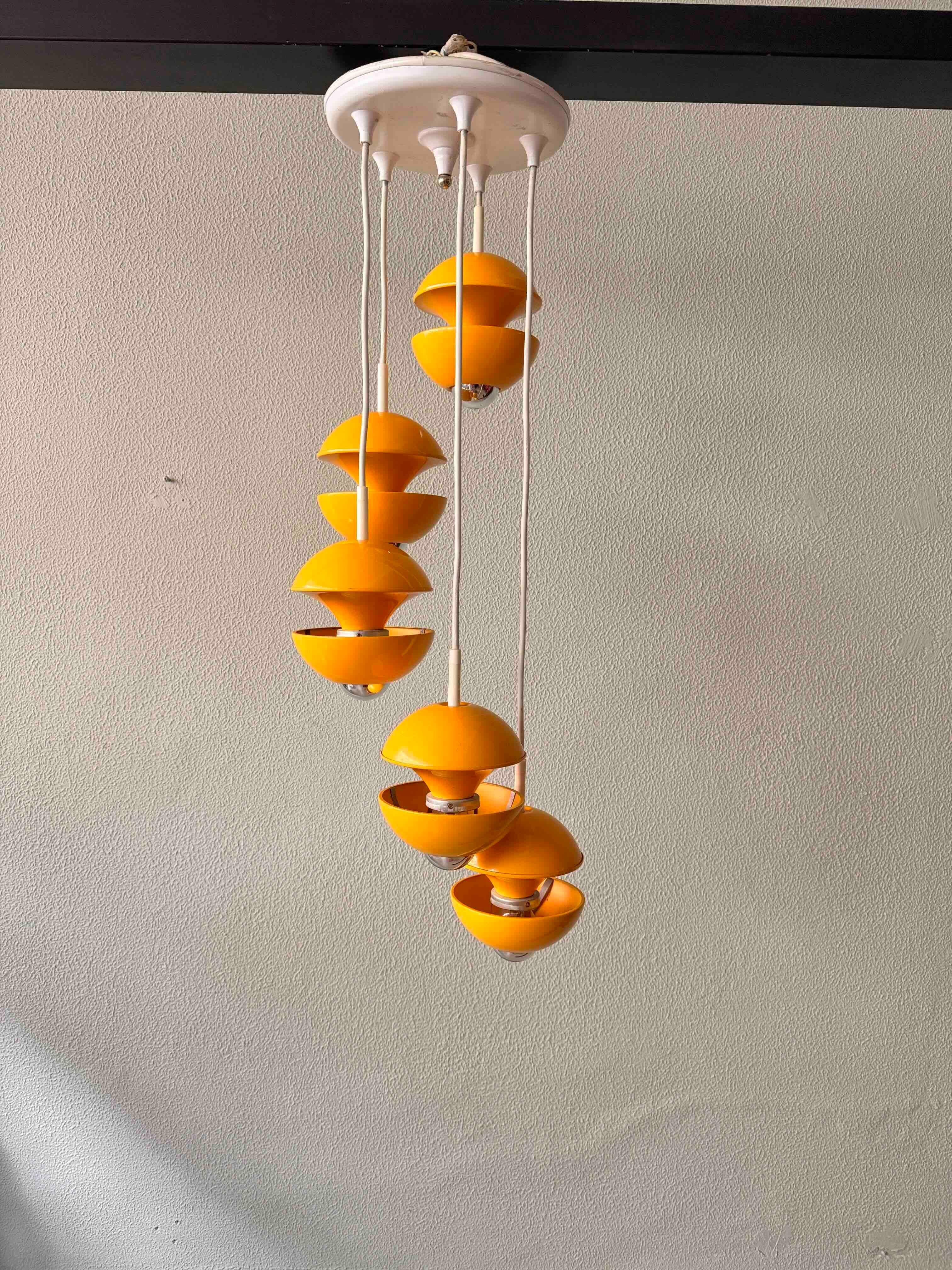 
This rare and stunning cascade lamp by Klaus Hempel for Kaiser Leuchten is a prime example of Space Age design at its finest. With its bold yellow color and futuristic sculptural form, this lamp embodies the optimism and innovation of the 1970s