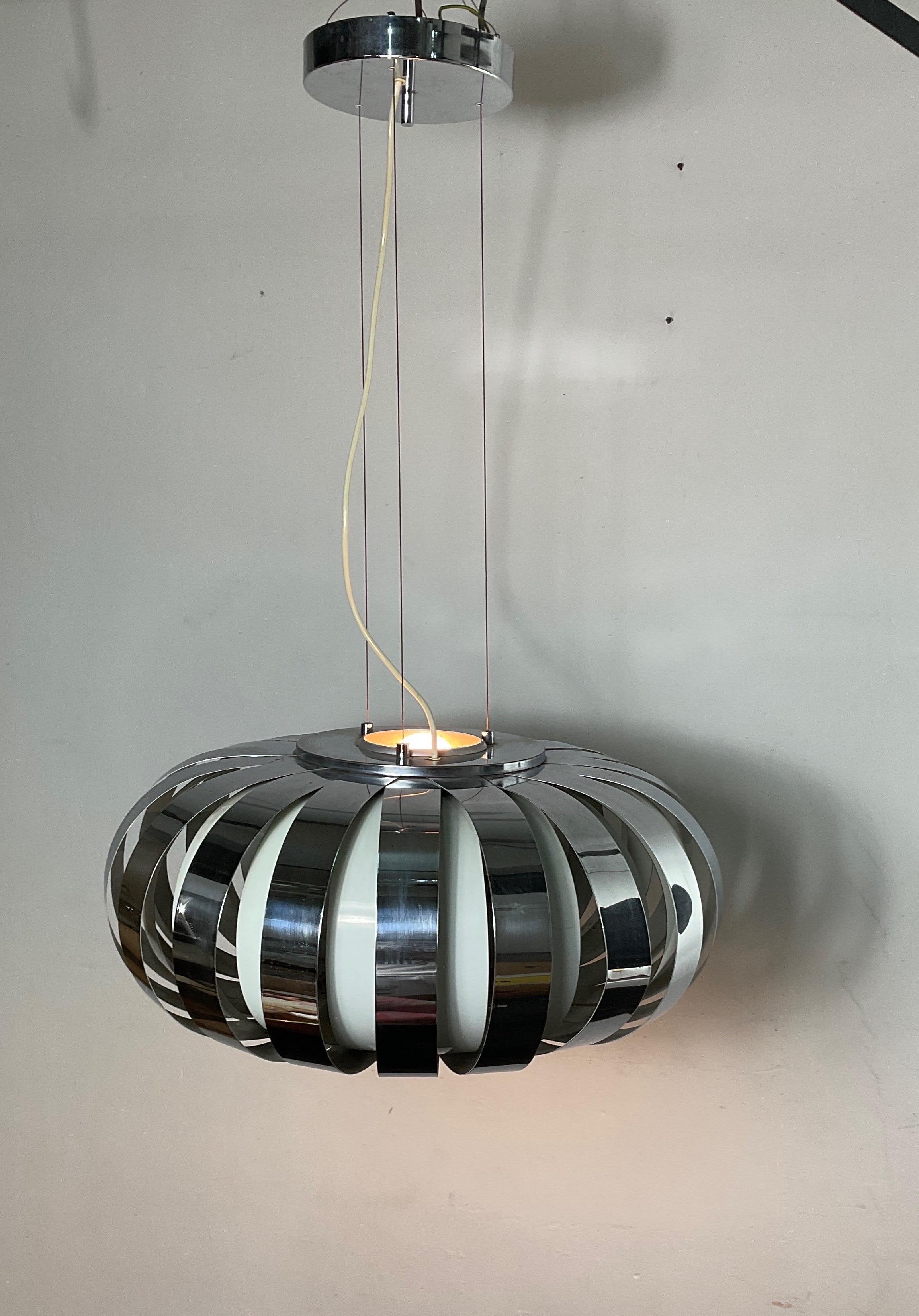 Space-age chandelier in chrome and lacquered steel from the 70s. With circular shape and measures 100 cm in height and 73 cm in diameter. The chandelier is in good condition with small wear and tear caused by both years and use. coloured plastics