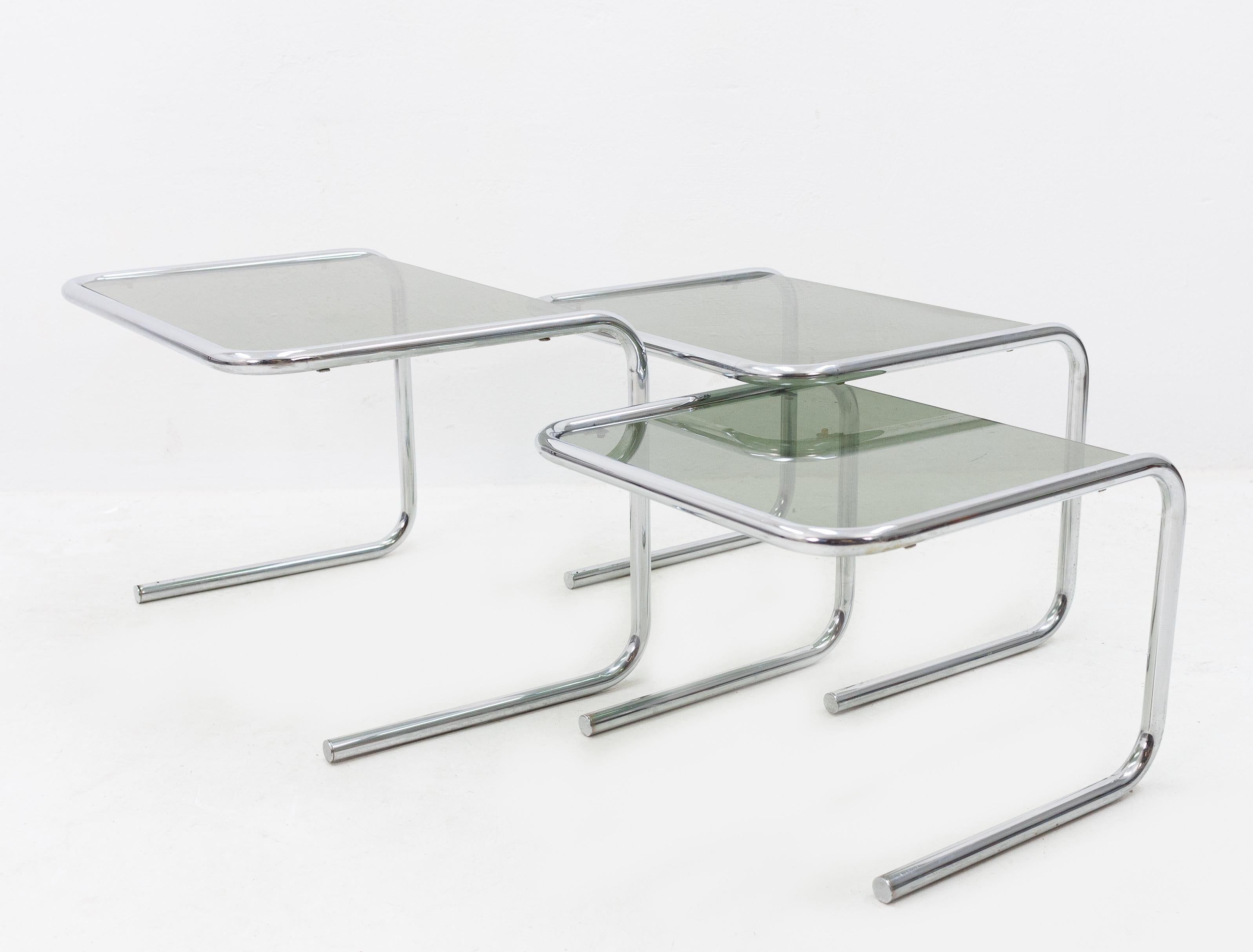 Set of three Bauhaus  nesting tables. Chrome frame with the original thick grey smoked glass. 1970s, in good condition.