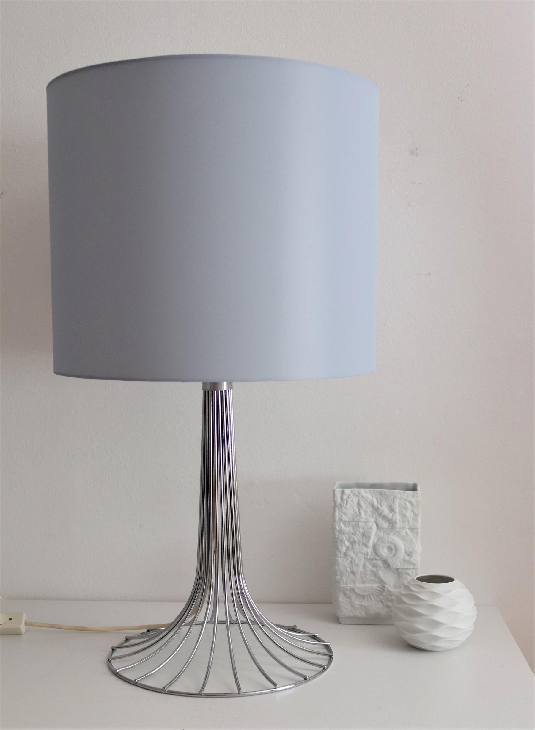 Gorgeous and tall chrome table lamp in original version made by Kinkeldey, Germany, in the 1970s.
The lamp's base is chrome plated and in very good to excellent condition.
The up-going bar is equipped with 4 original bulb holders for Edison bulbs,
