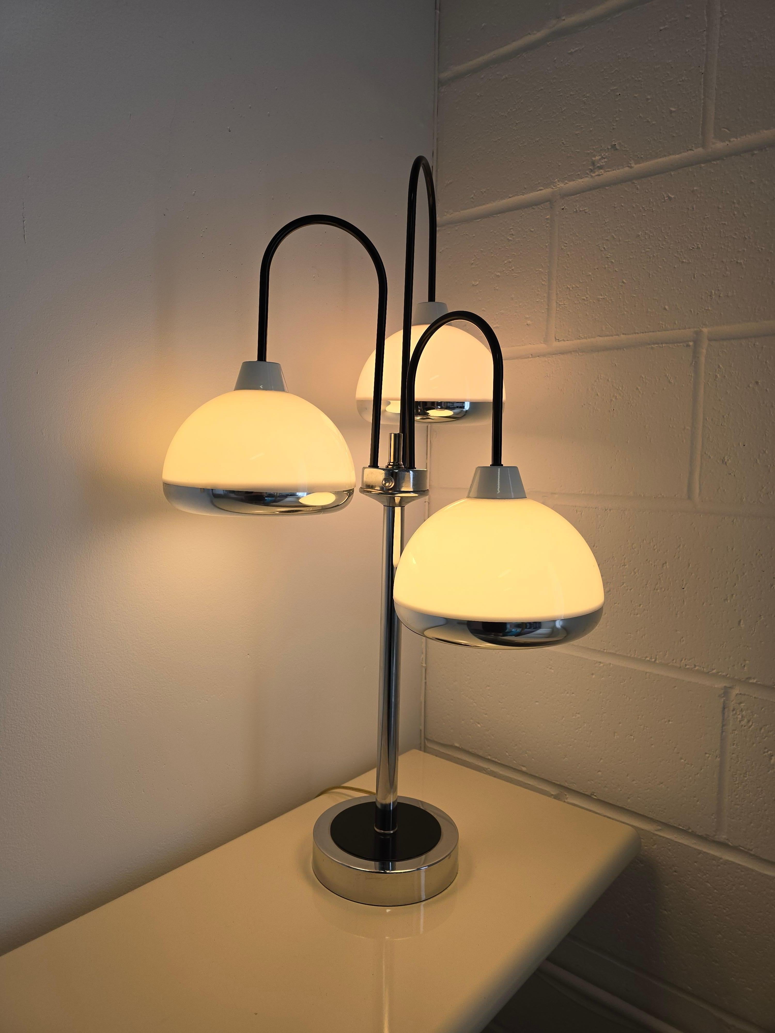 Super cool space age style Chrome lamps with acrylic shades. These awesome table Chrome lamps have three acrylic shades with a chrome rim. The chrome base resembles a waterfall with the three shades in a dome shape which are facing downwards. The