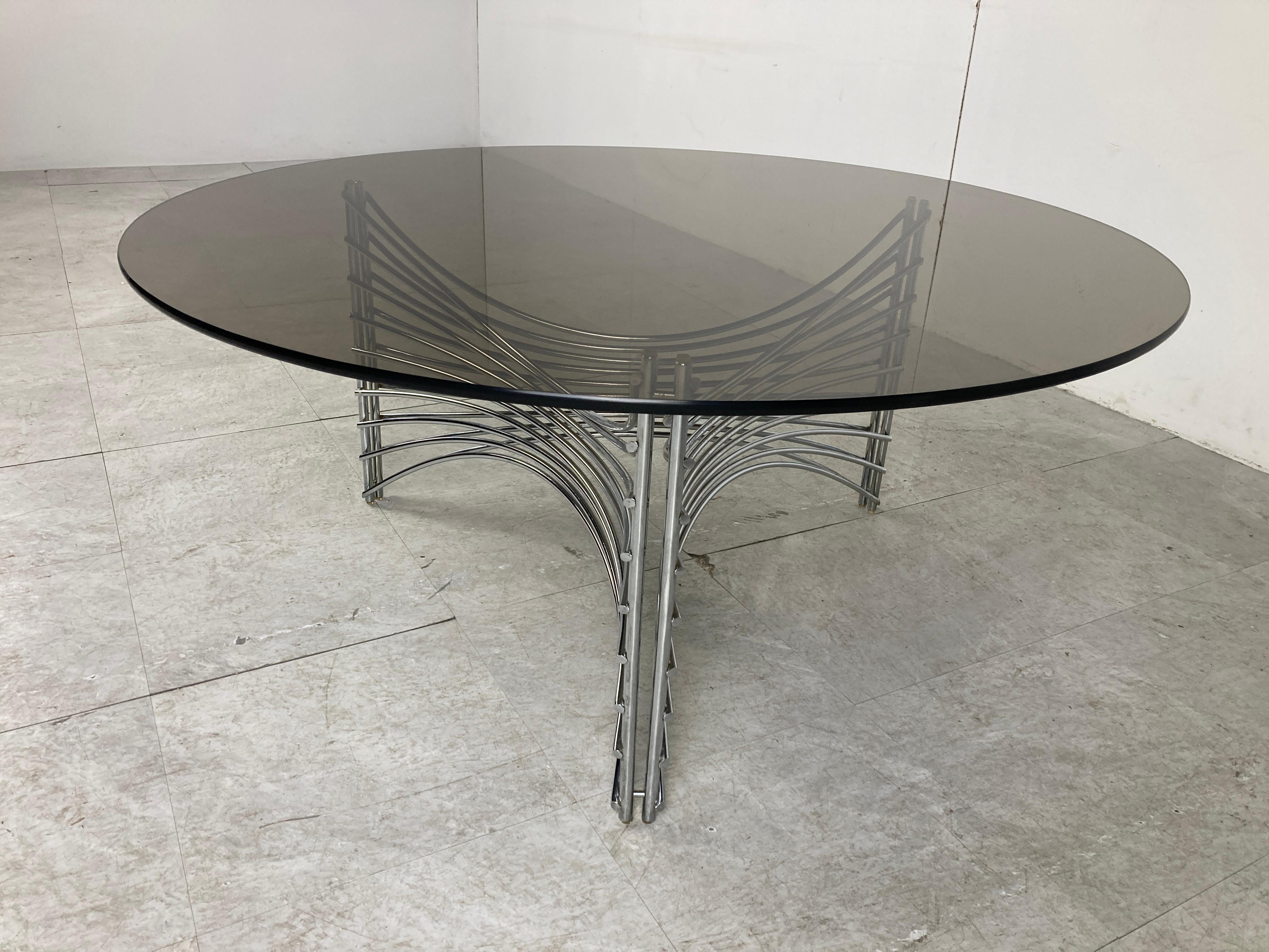 Space age era coffee table with a chromed metal wire base and a round smoked glass top.

1970s - Germany

Good condition

Dimensions:
height: 42 cm / 16.53