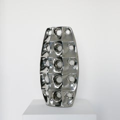 Vintage sculptural Space Age style vase in chromed ceramic, with holes