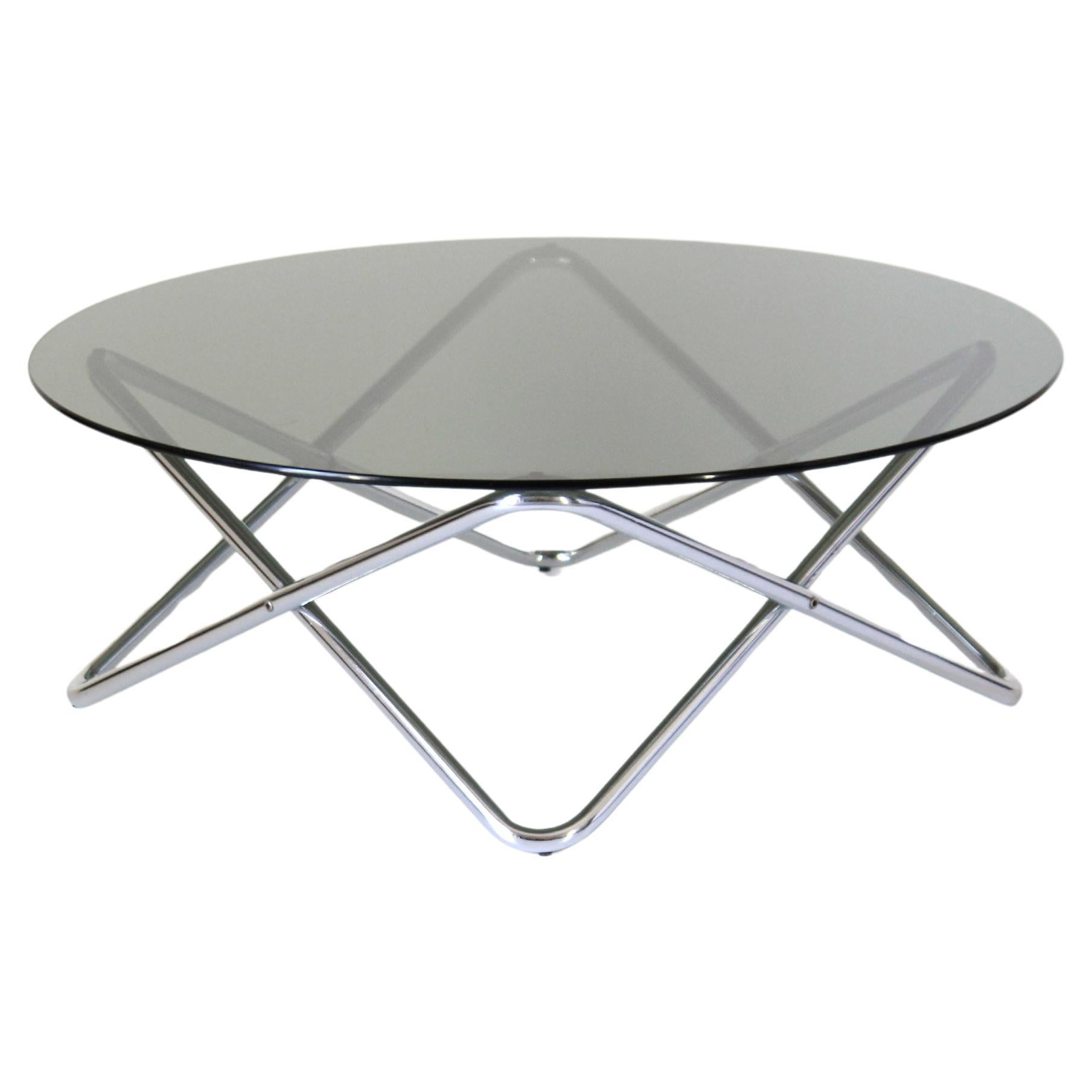 Vintage Chromed Coffee Table with Smoked Glass Top, Space Age Style, Italy, 1970s

This striking vintage coffee table from the 1970s captures the essence of Italian Space Age design with its bold geometric form and futuristic aesthetic. 

The round