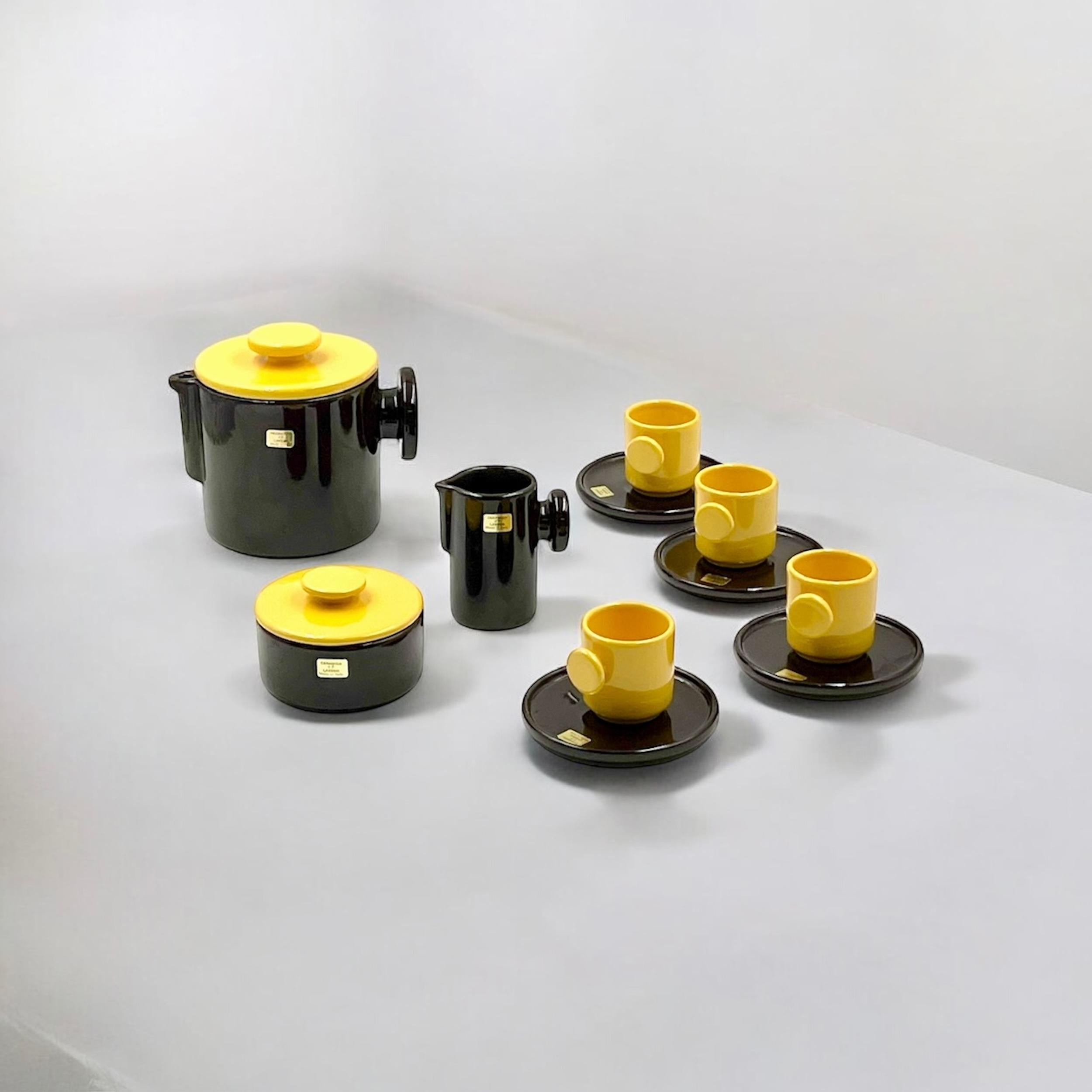 Add a touch of refined Space Age decor to your home with this exquisite 1970s coffee set by Pareschi Ceramica Laveno. The set, composed of a coffee pot, milk jug, sugar bowl, and four cups with saucers, captivates with its striking yellow and brown