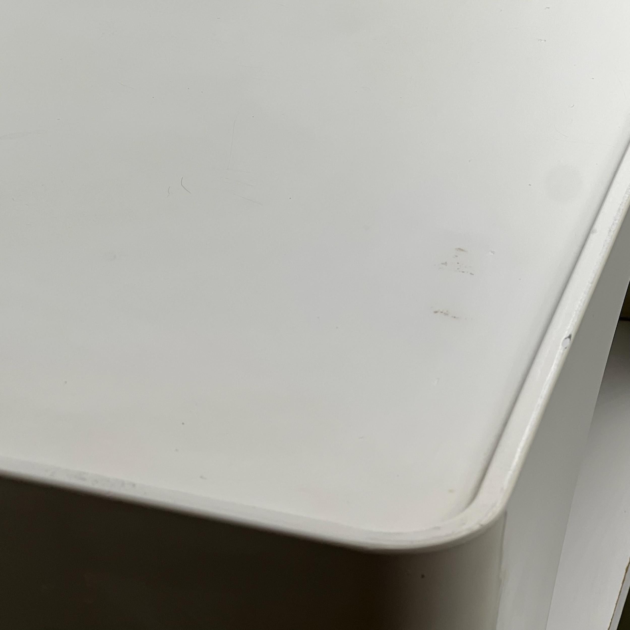 A refined example of 1970s Space Age design, this square coffee table with wheels epitomizes the era's forward-thinking aesthetic. The smooth white plastic structure, adorned with large circular cutouts, evokes a minimalist yet elegant feel, while
