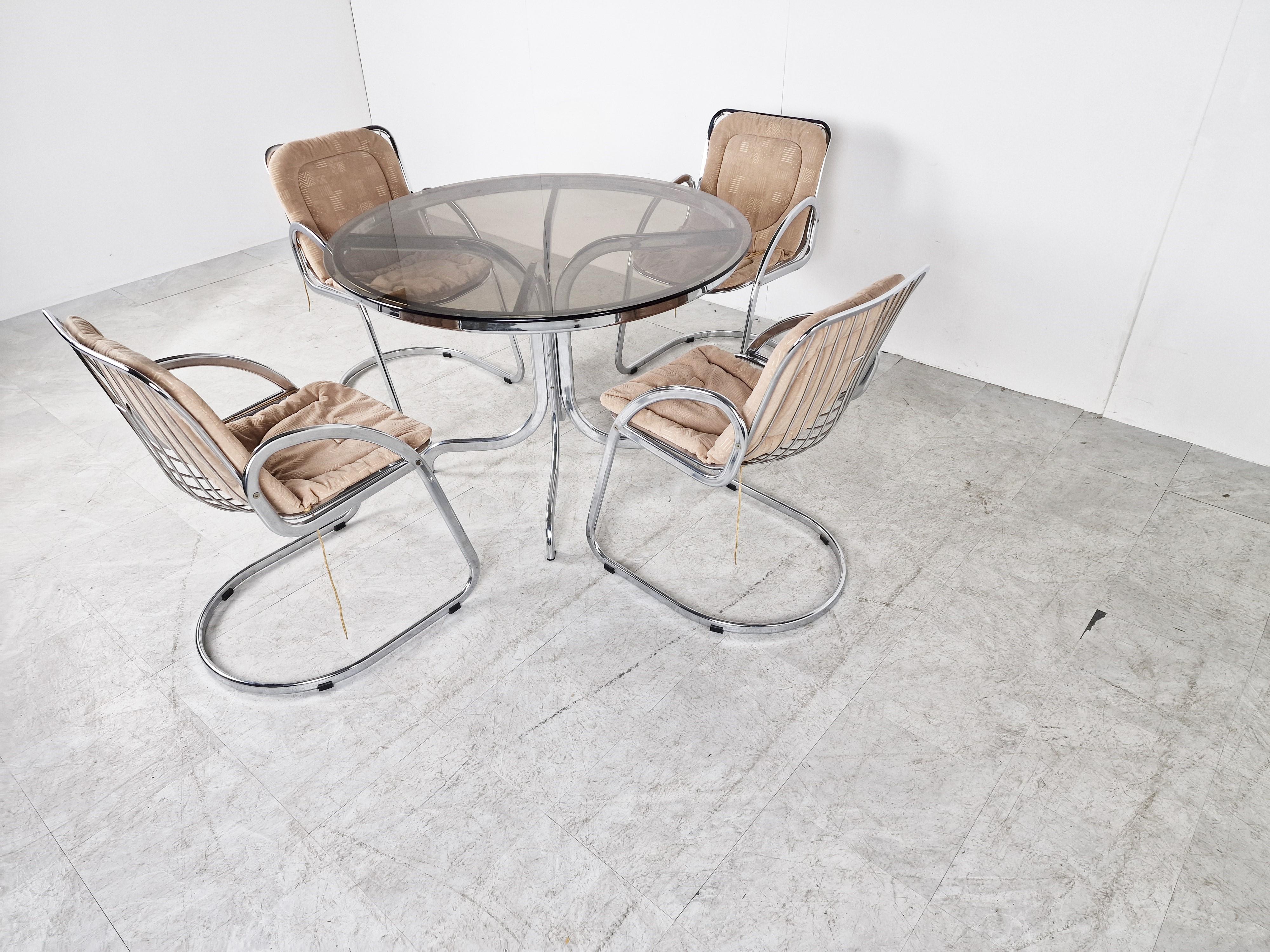 Mid-Century Modern chromed dining chair set by Gastone Rinaldi.

The set consists of 4 chairs with their original fabric cushions and a chromed and smoked glass dining table

Good condition

1970s - Italy

Dimensions:

Table:
Height: