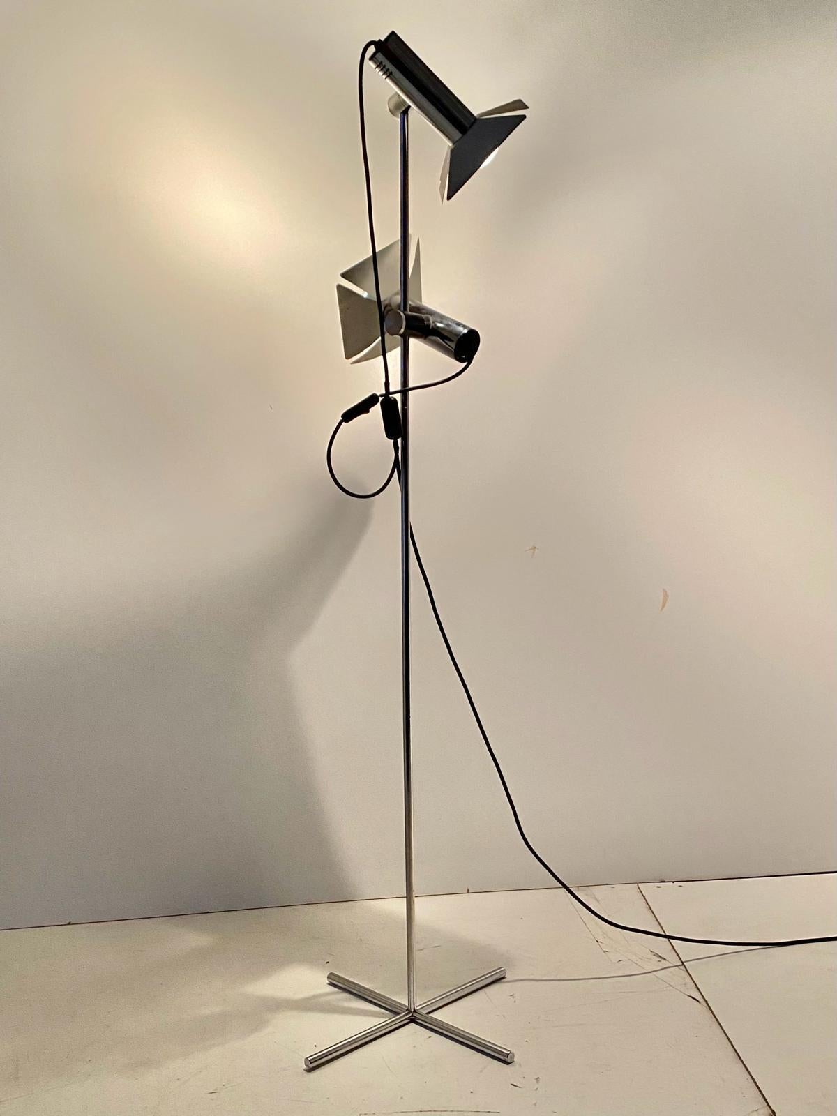 Vintage chromed floor lamp in pure space age style. Two adjustable lights spots on a minimal base. All structure made in chromed iron. Manufactured in Italy in the 1970s. Electric parts has been revised. Chromed has been polished. In really good