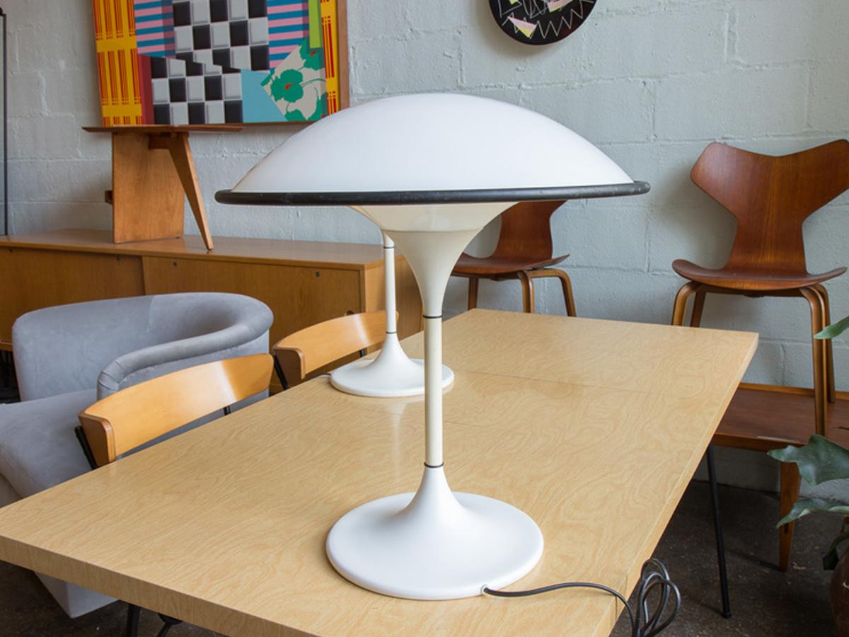 So mod! Single white UFO-shaped table lamp by Fog & Mørup, circa 1960. A groovy table lamp that has been rewired for US outlets. Casts a soft light due to the shades that wrap all around the fixtures. In very good condition with a couple of minor