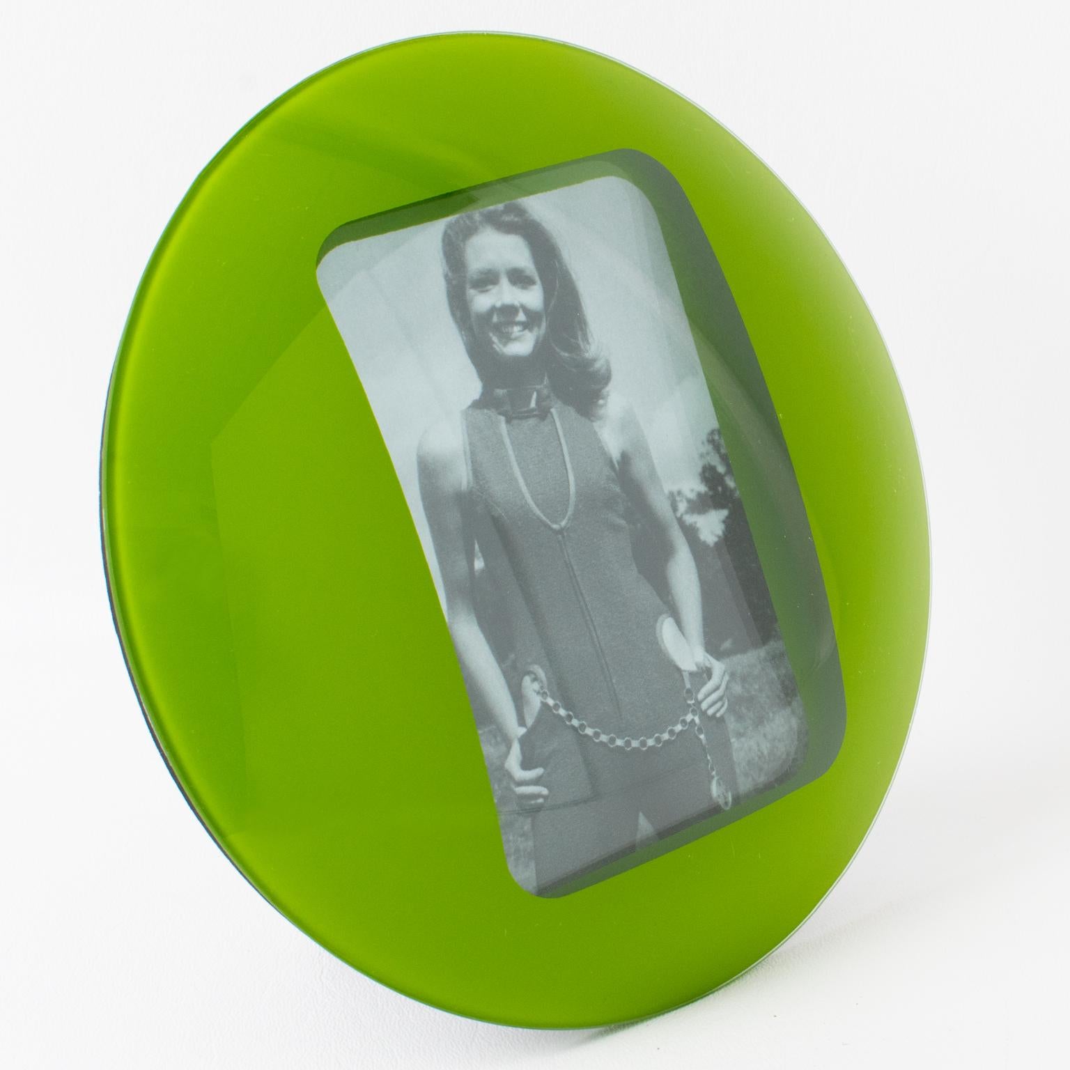 This stylish 1960s Space Age green glass picture photo frame features a round domed design with a kinetic effect. The easel and the back are covered with black paper. The photo frame can only be displayed in the portrait position. There is no