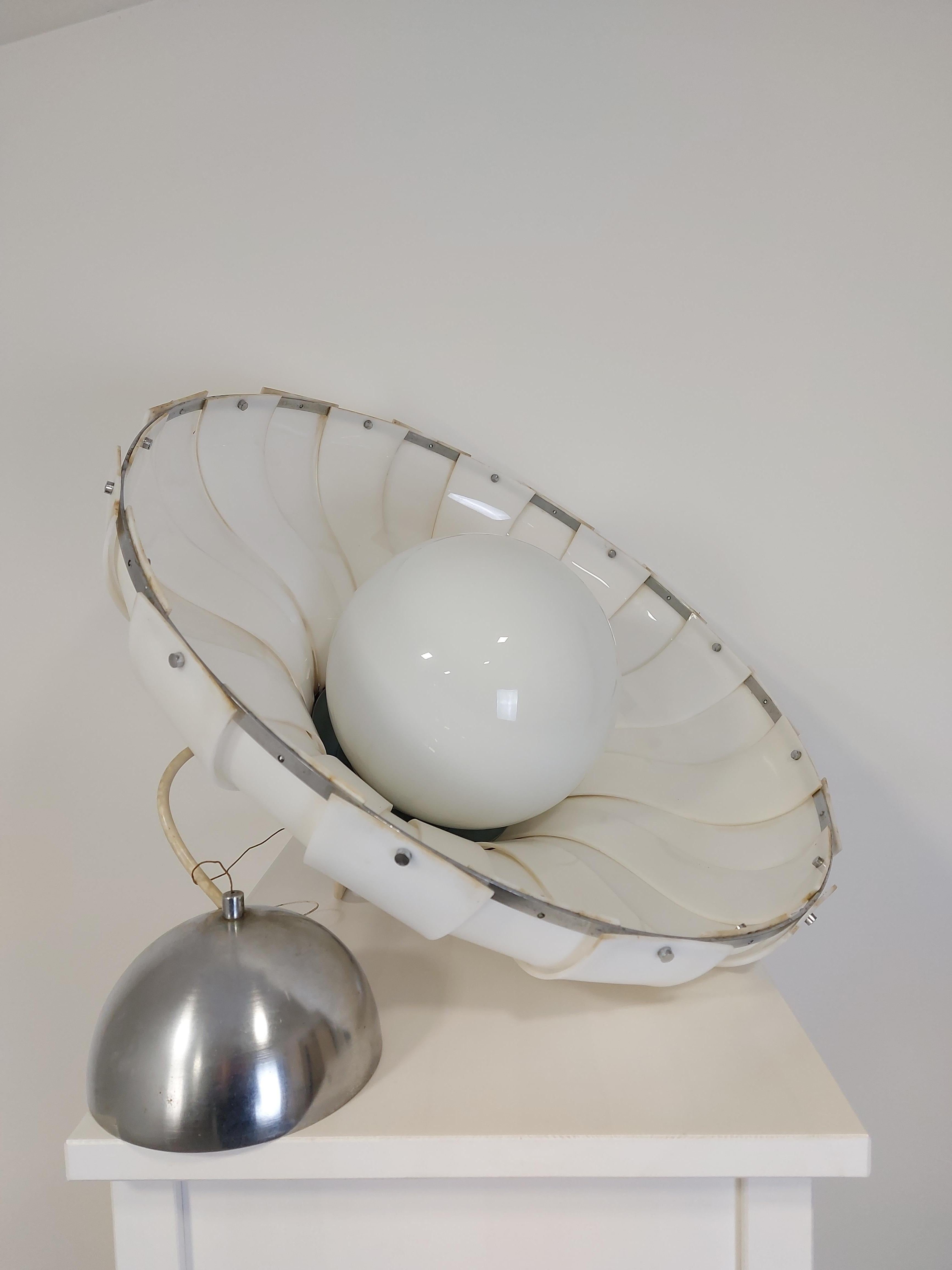 Space-age pendant '70s. Shade is made of chrome top, white ABS plastic and opaline globe.

It was produced in Meblo by Harvey Guzzini. The two studios used to partner in production and sales with collaborative branding during their prime
