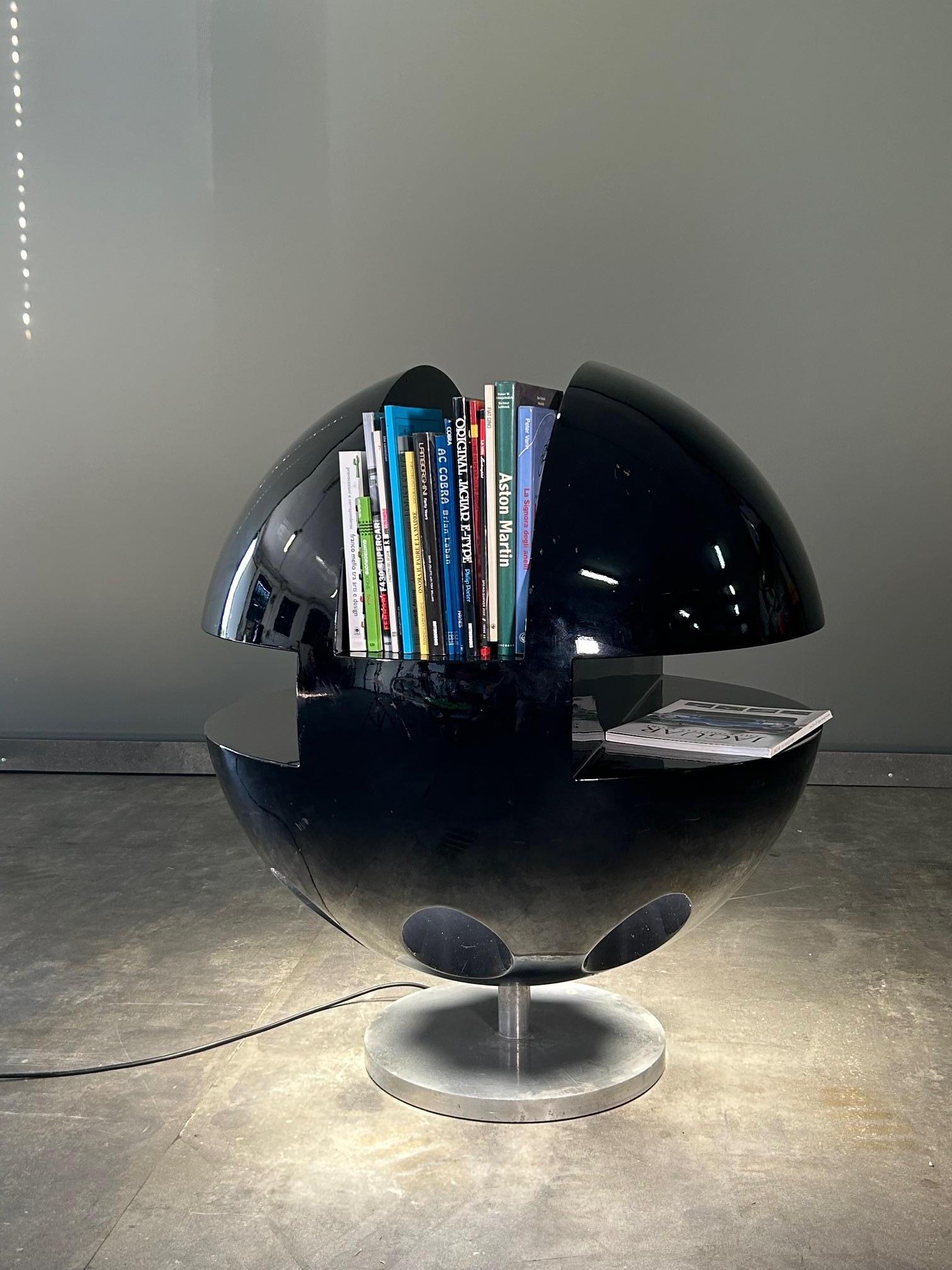 Space Age revolving sculptural illuminated bookcase attributed to Joe Colombo; aluminum base, fiberglass structure, 8 bulbs inserted in the lower part controlled by a foot switch. Very nice condition. 

