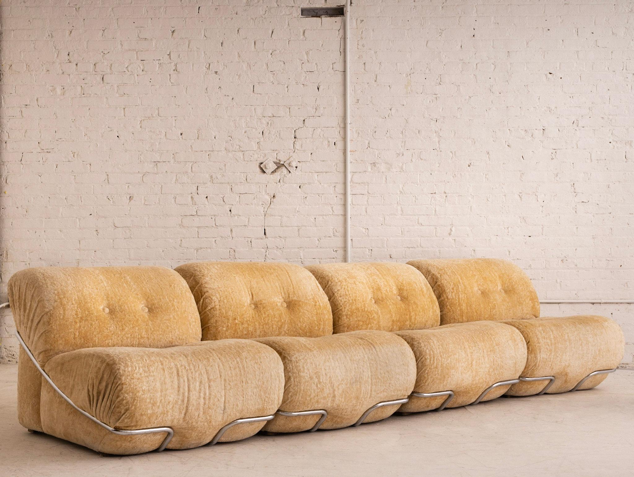A Space Age modular sectional. 4 pieces can be arranged at your discretion. Tubular chrome wraps around the frame of each piece. Original crushed velvet upholstery. Sourced outside of Florence, Italy.

Individual pieces measure 30” wide, 36” deep,