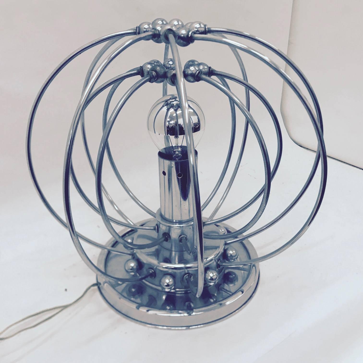 Rare vintage chrome Italian table lamp in the style of Studio Tetrarch, made in the 1960s, good conditions overall.
It works with both 110 and 220 Volt and needs regular e27 bulb. The Table Lamp, inspired by the iconic Pistillo Lamp, is a highly