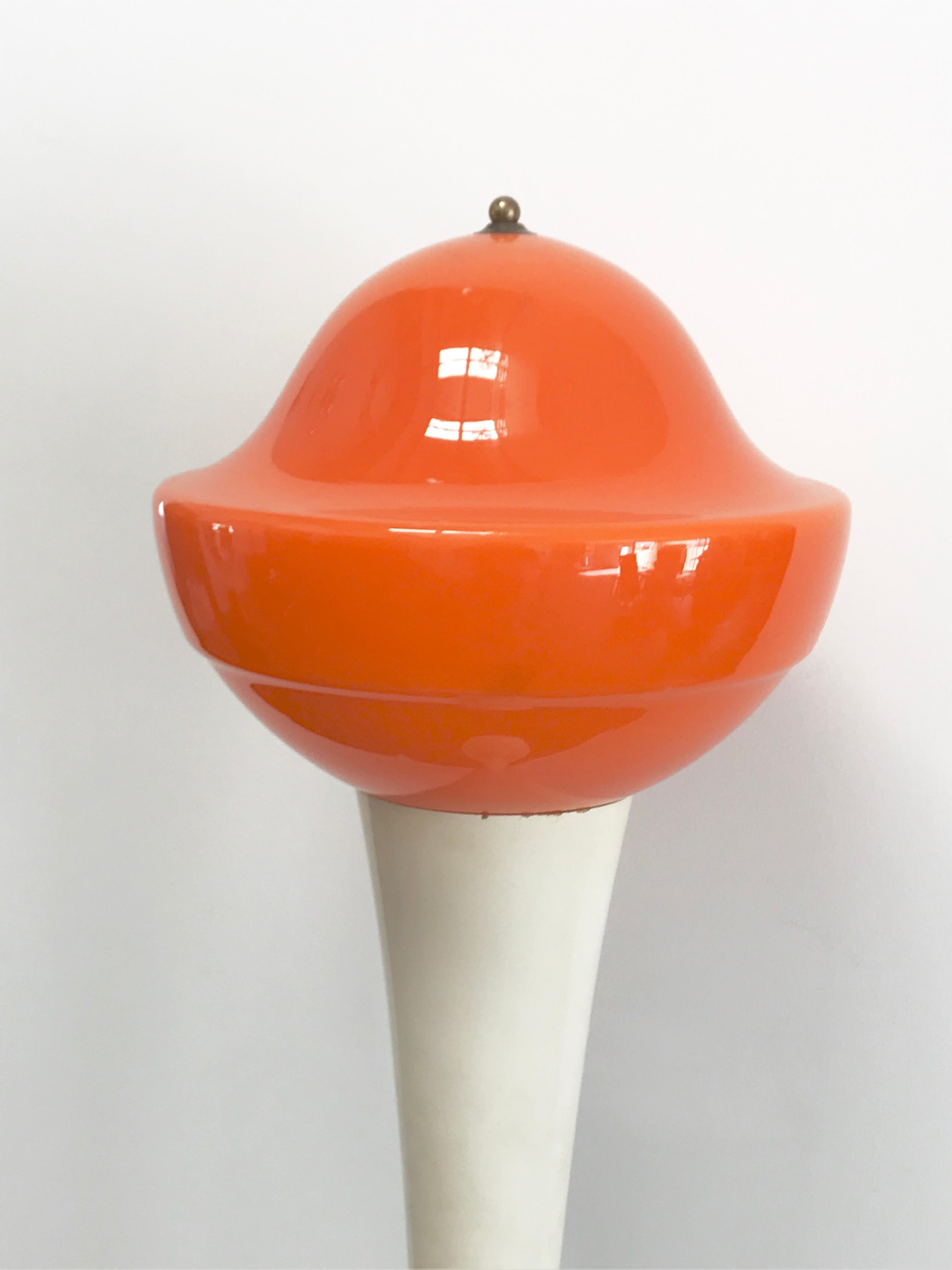 Space Age floor lamp from Italy, shade in Orange Murano glass and body in wood and a brass rig in the middle and on the top of the head of the lamp to keep the all the parts together.