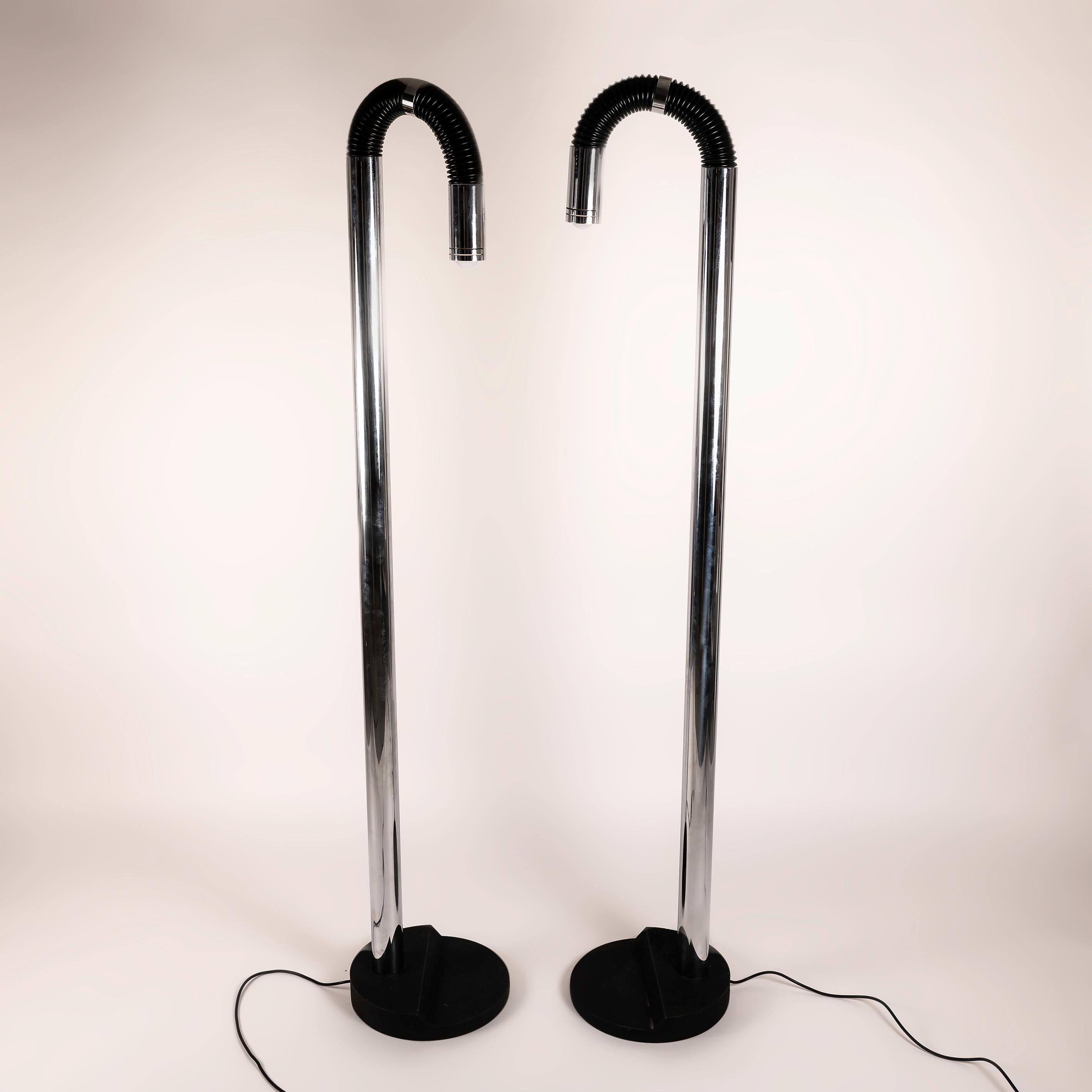 Step into the future with this pair of Space Age Italian floor lamps from the 1970s, an iconic fusion of form and function. Crafted from lacquered iron and chromed metal, these lamps exude a retro-futuristic charm. The sleek lines and avant-garde